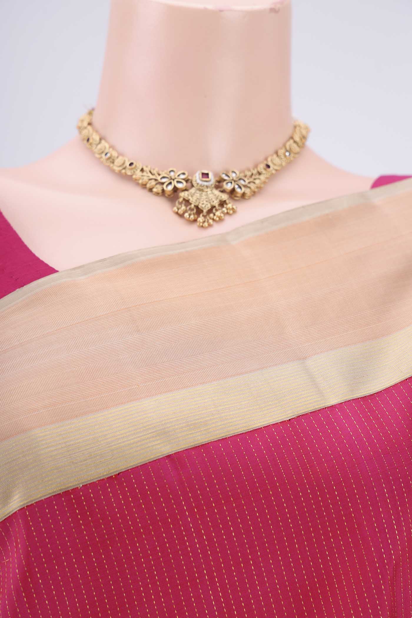 Border image of Pure Silk Pure Zari Rani Pink Dual Tone Kanjivaram Saree with Stripes on the body and Zari Border. 