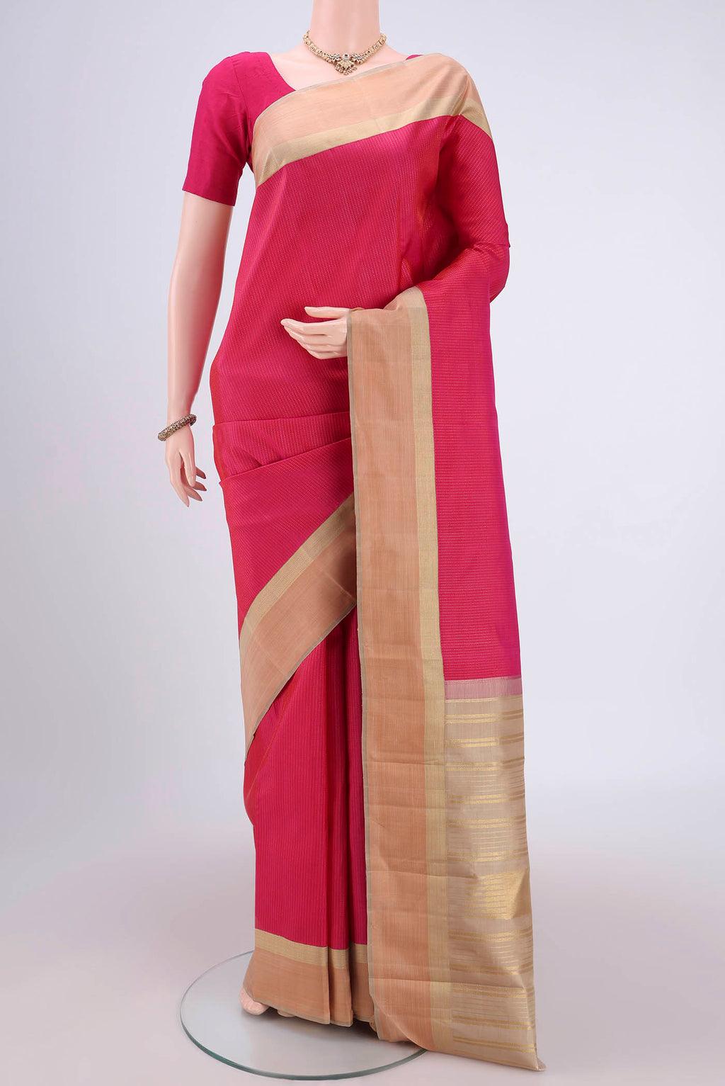 Pure Silk Pure Zari Rani Pink Dual Tone Kanjivaram Saree with Stripes on the body and Zari Border.  displayed on a mannequin