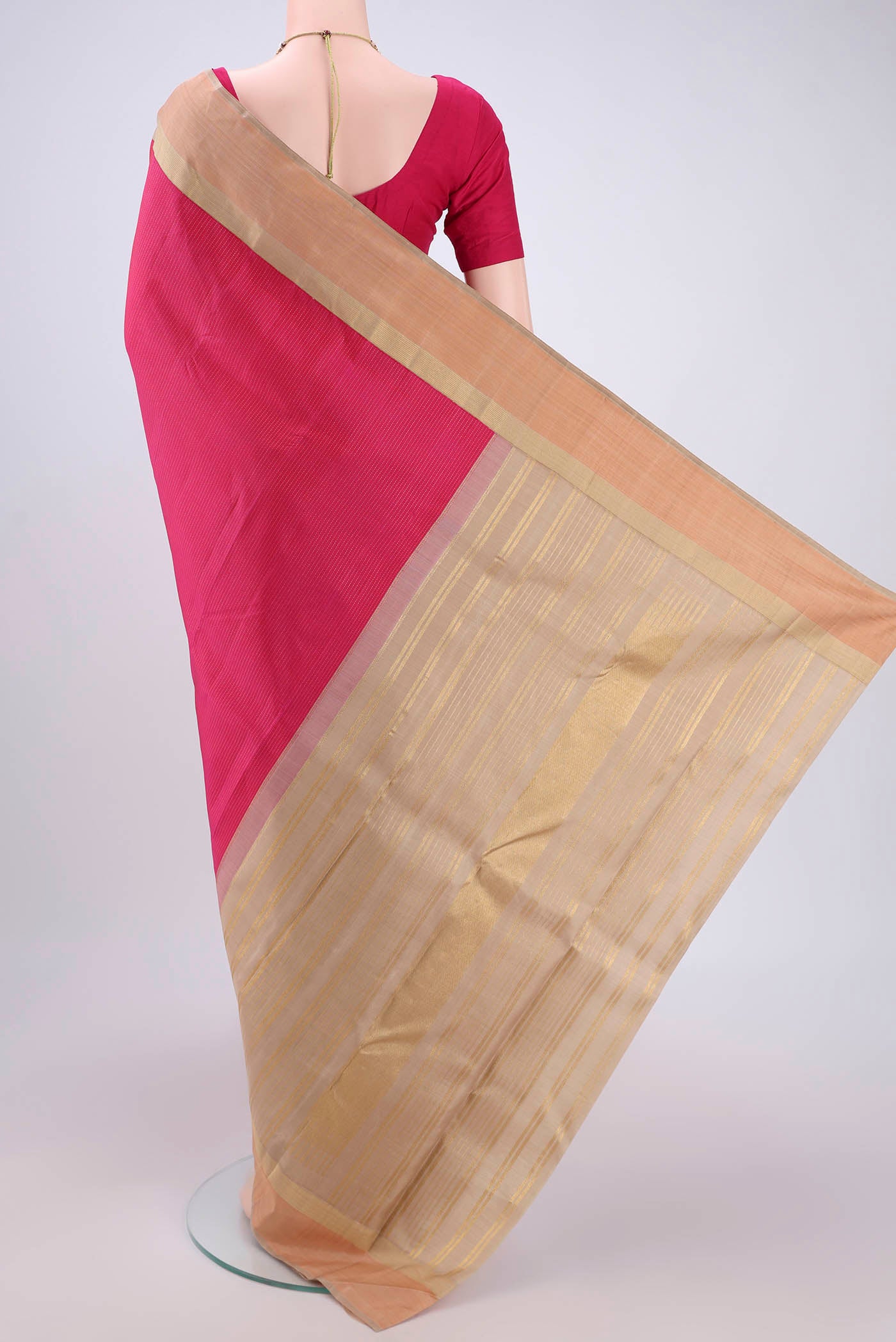 Flat view of Pure Silk Pure Zari Rani Pink Dual Tone Kanjivaram Saree with Stripes on the body and Zari Border. 