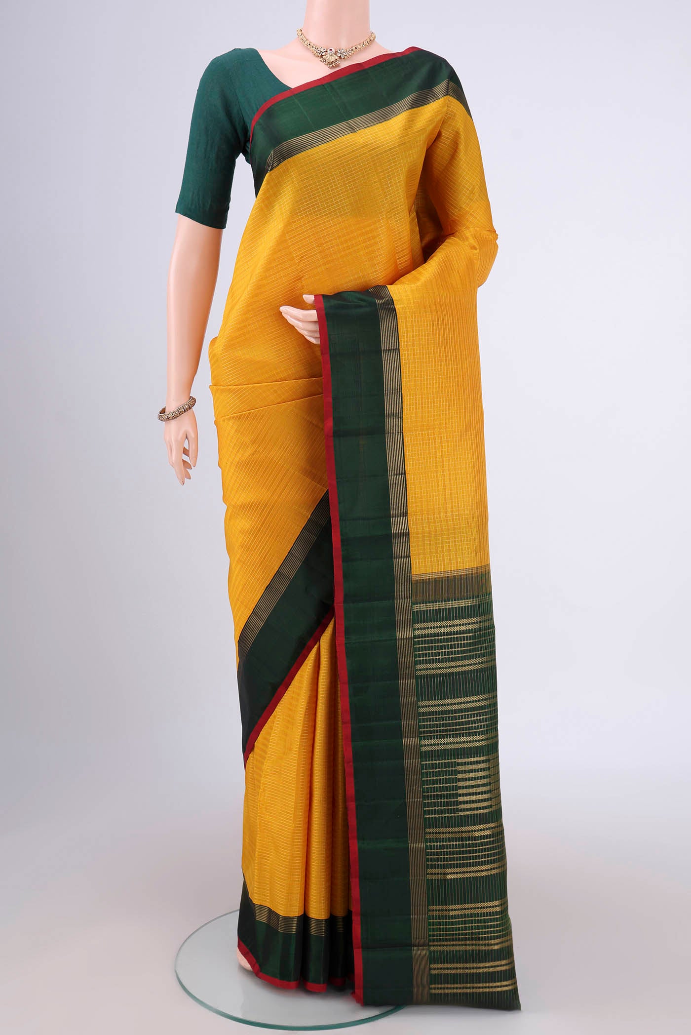 Pure Silk Pure Zari Yellow Kanjivaram Saree with Checked design on the body and Zari Border.  displayed on a mannequin