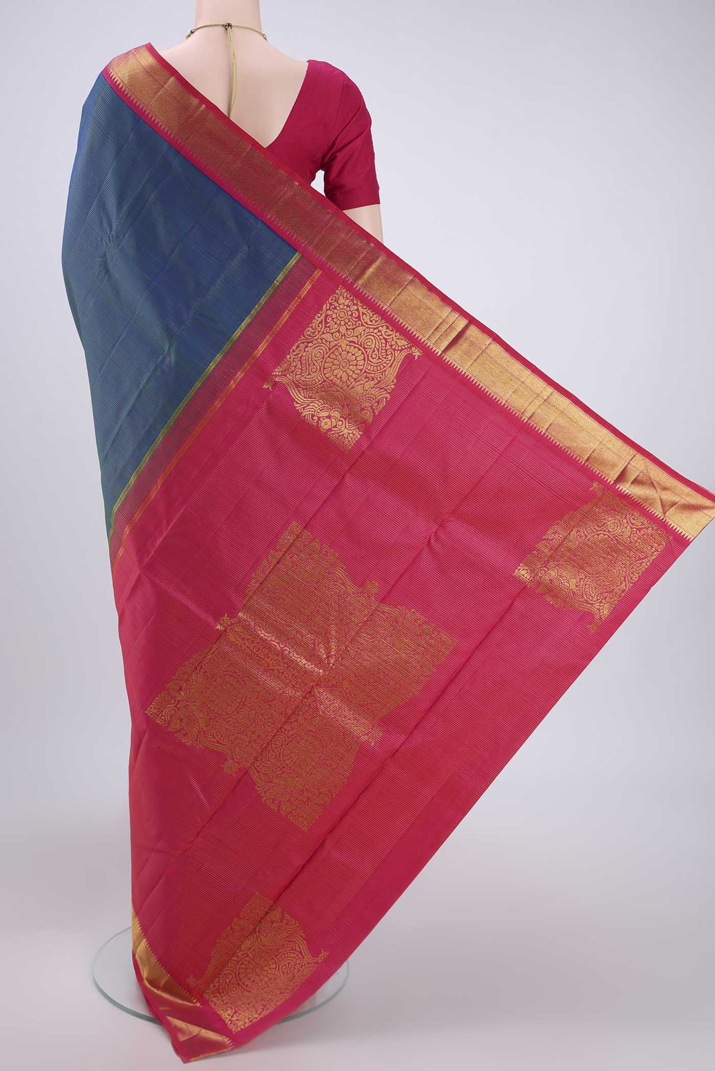 Flat view of Pure Silk Pure Zari Peacock Blue Dual Tone Kanchipuram Saree with Stripes on the body and Temple Border. 