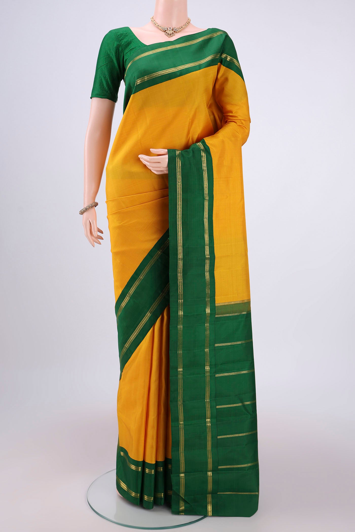 Pure Silk Pure Zari Mustard Kanjivaram Saree with Plain Body and Temple Border.  displayed on a mannequin