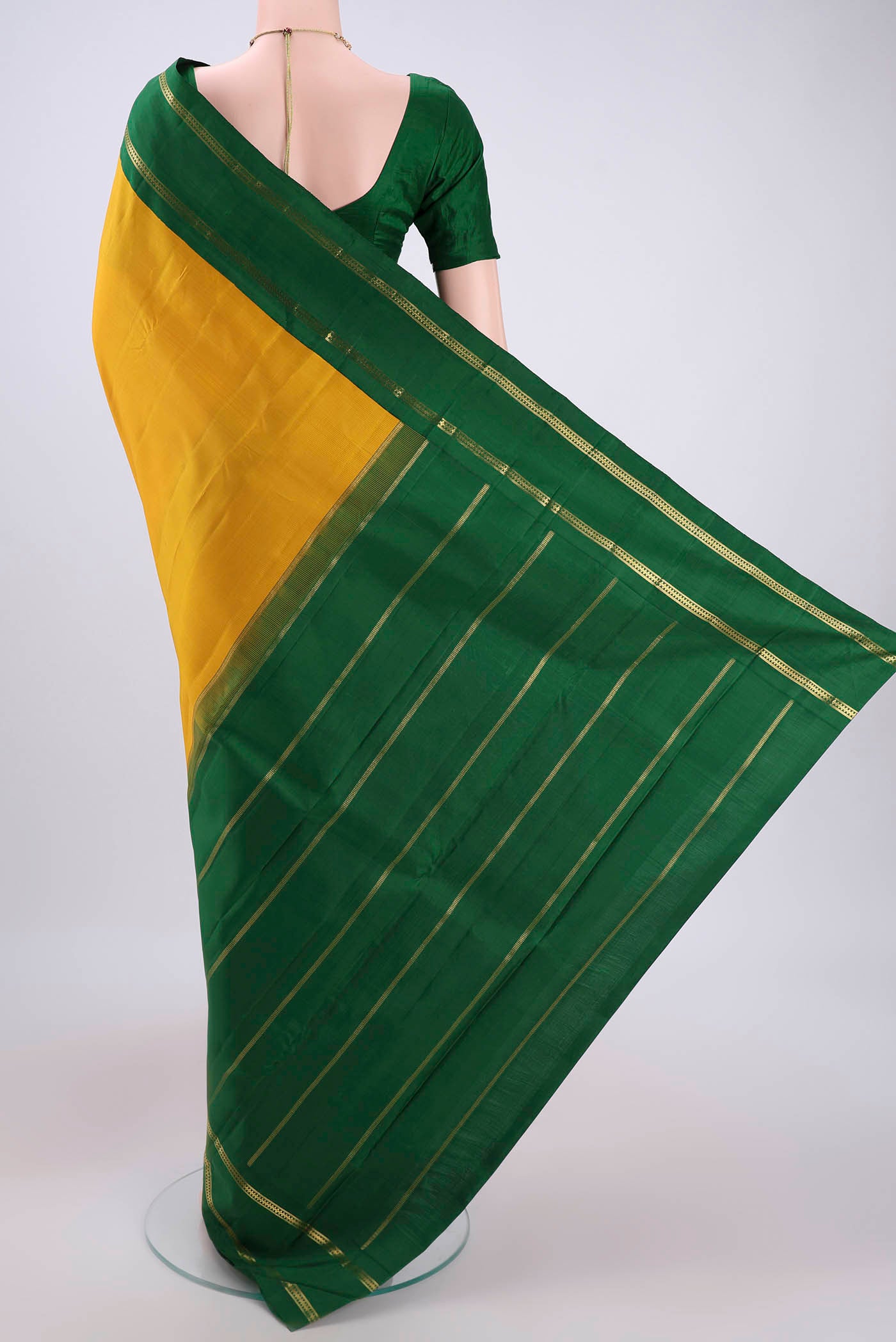 Flat view of Pure Silk Pure Zari Mustard Kanjivaram Saree with Plain Body and Temple Border. 