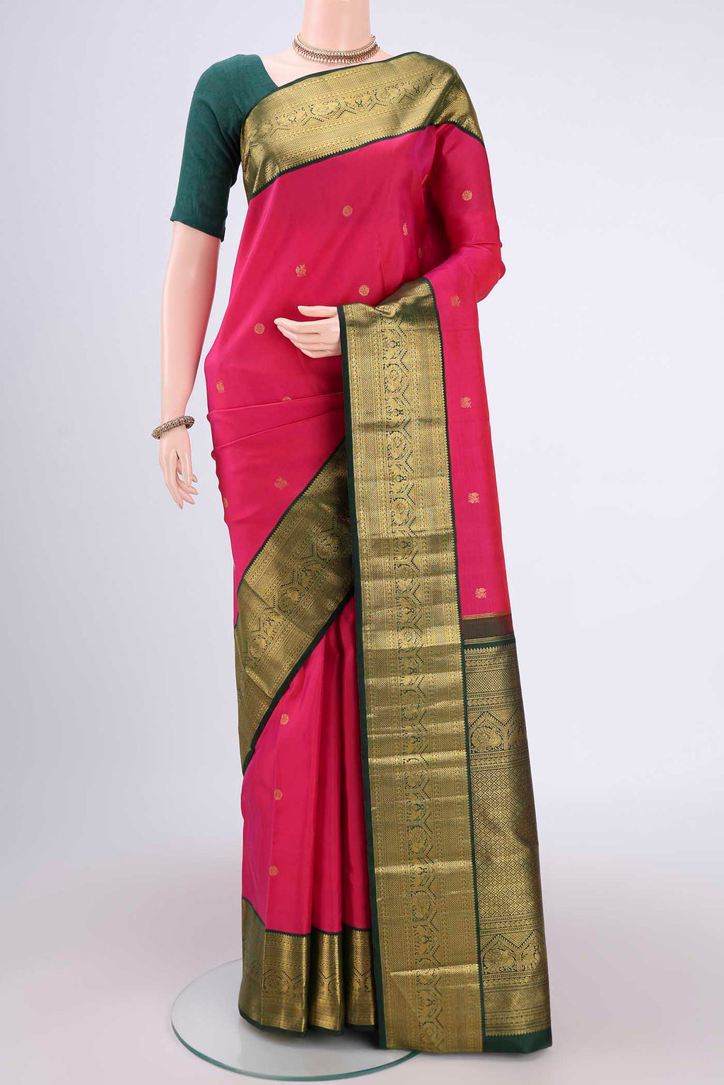 Pure Silk Pure Zari Rani Pink Kanchipuram Saree with Zari Butta on the body and Zari Border.  displayed on a mannequin
