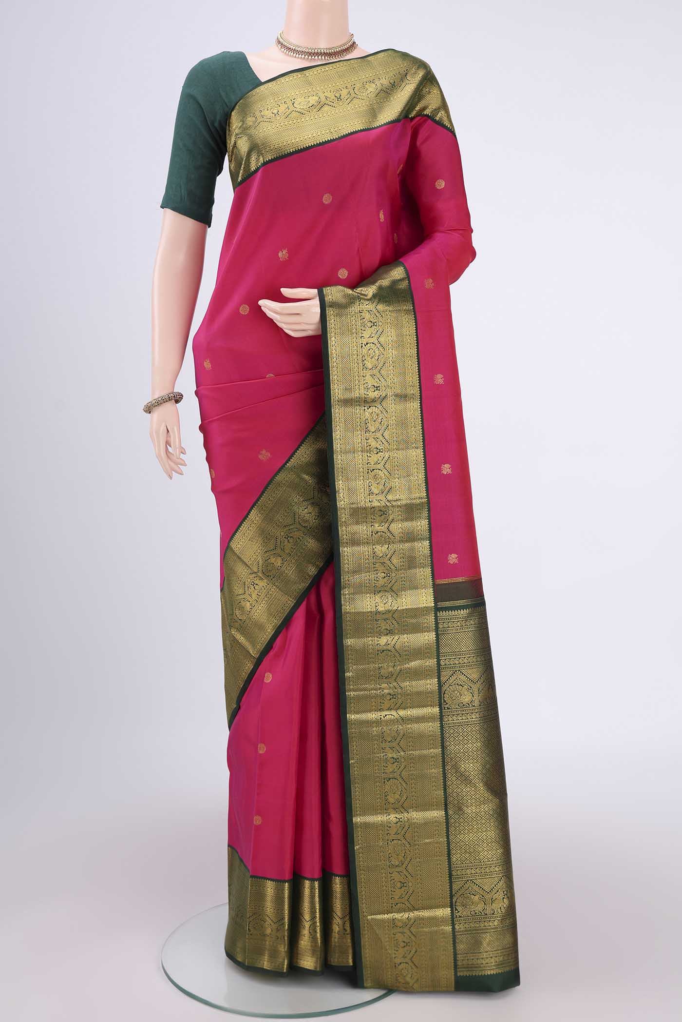 Pure Silk Pure Zari Rani Pink Kanchipuram Saree with Zari Butta on the body and Zari Border.  displayed on a mannequin