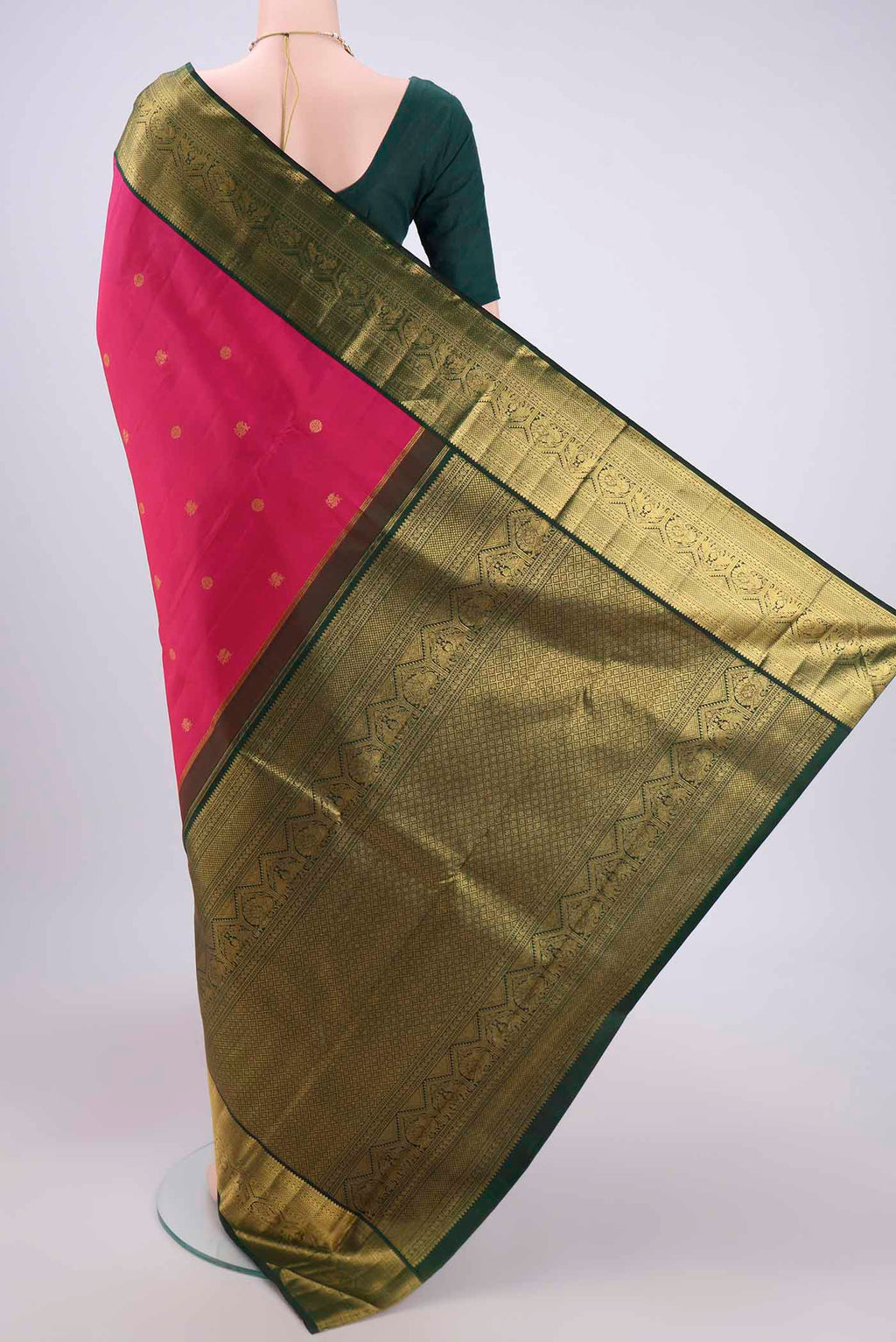 Flat view of Pure Silk Pure Zari Rani Pink Kanchipuram Saree with Zari Butta on the body and Zari Border. 