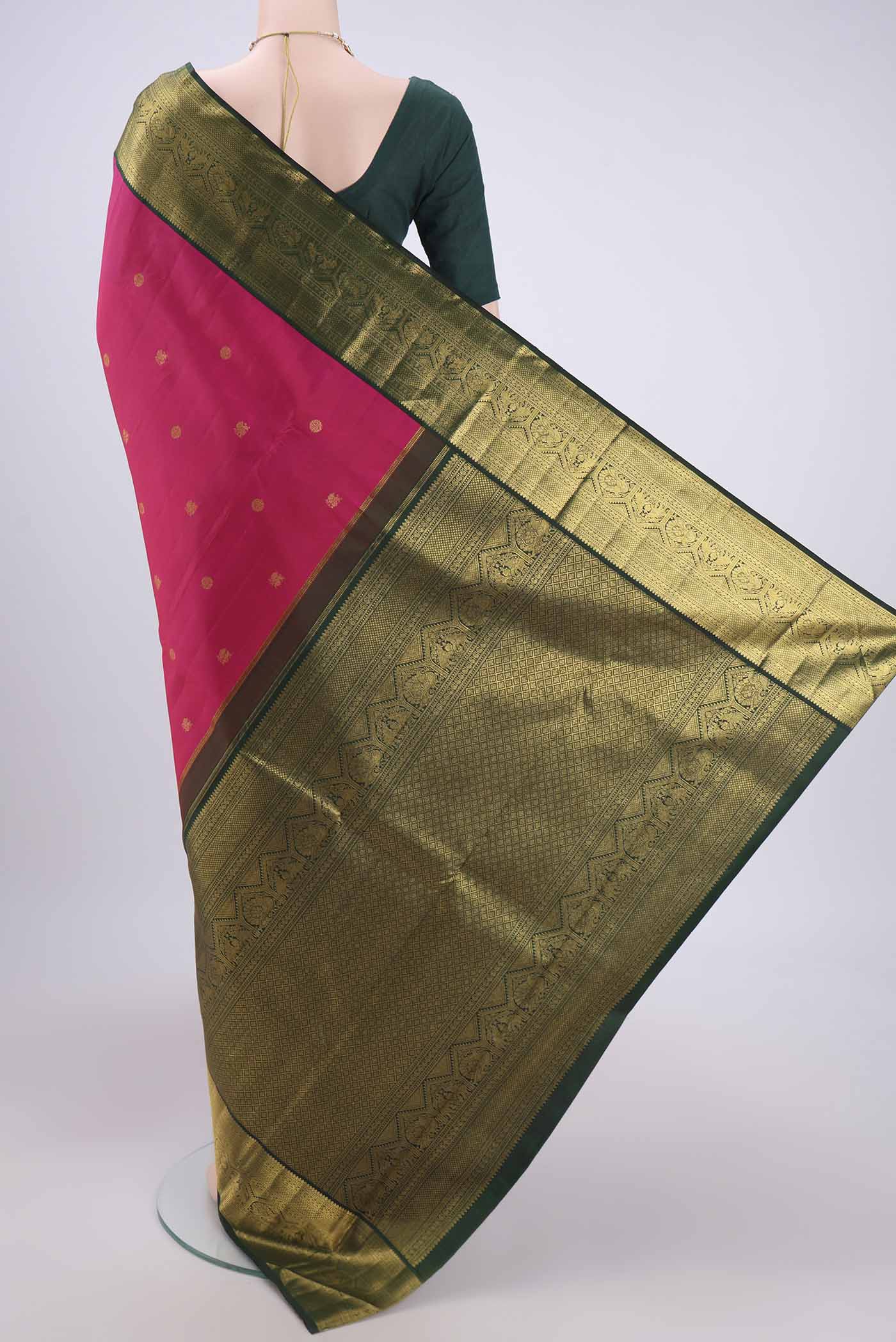 Flat view of Pure Silk Pure Zari Rani Pink Kanchipuram Saree with Zari Butta on the body and Zari Border. 
