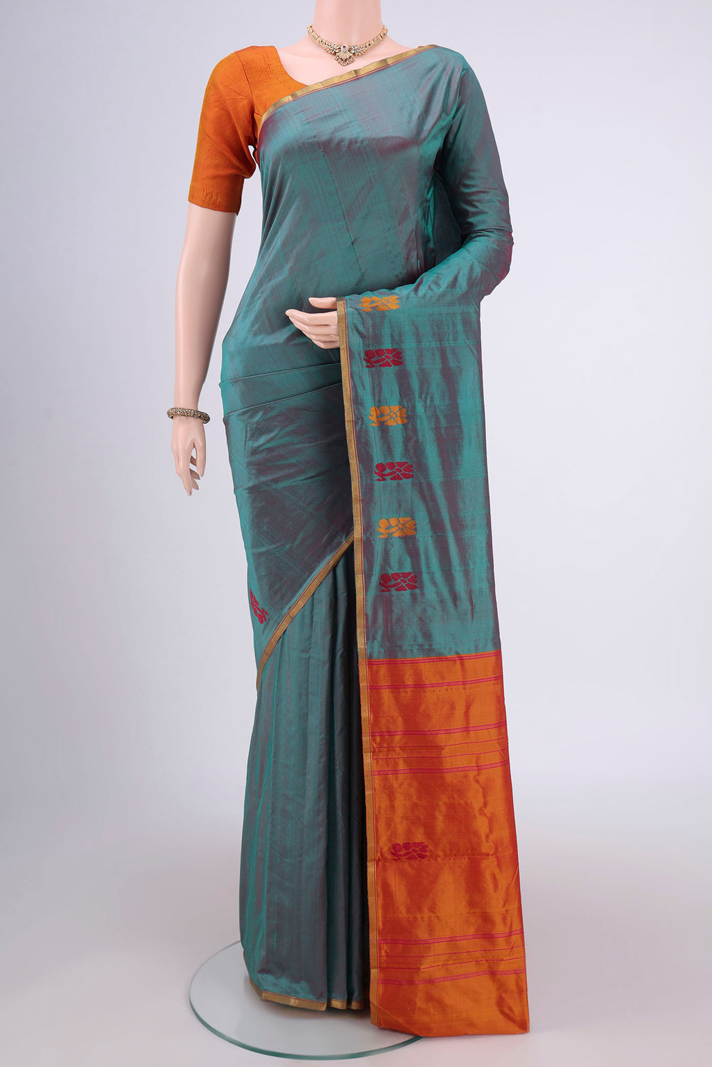 Sea Green Kanchipuram Silk Saree with Plain Body and Zari Border.  displayed on a mannequin