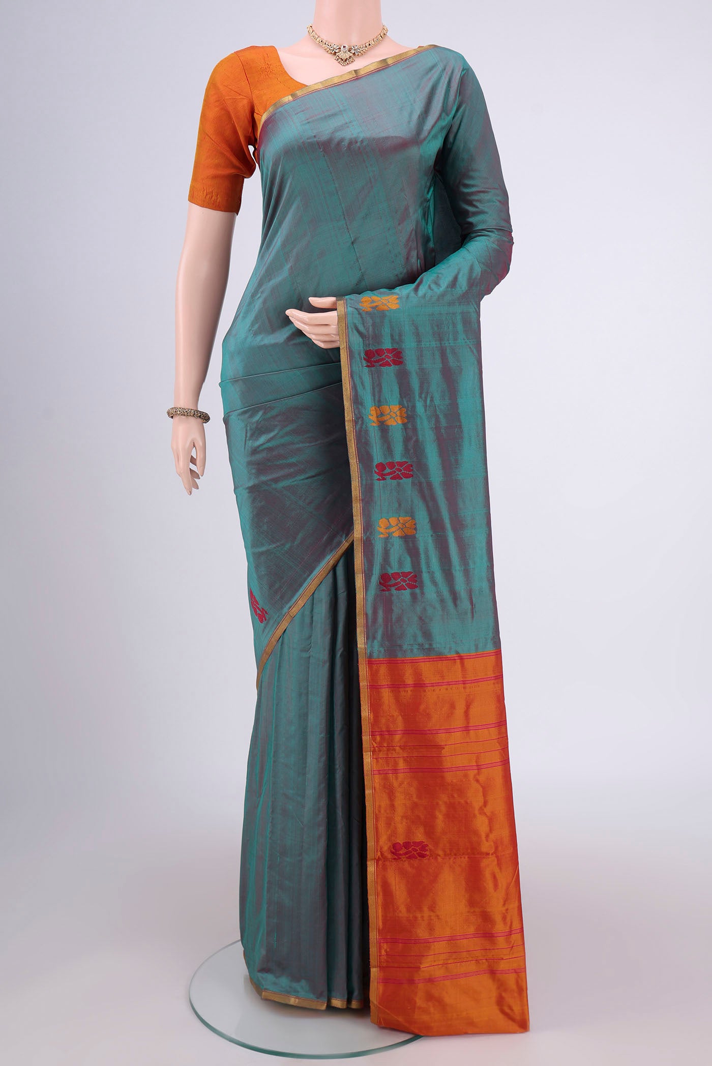 Sea Green Kanchipuram Silk Saree with Plain Body and Zari Border.  displayed on a mannequin