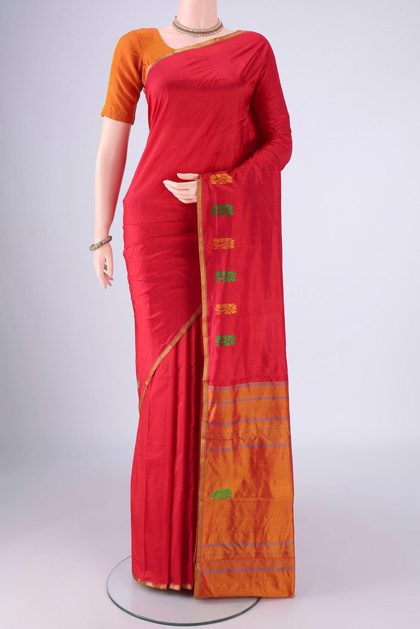 Red Kanchipuram Silk Saree with Plain Body and Thread Border.  displayed on a mannequin