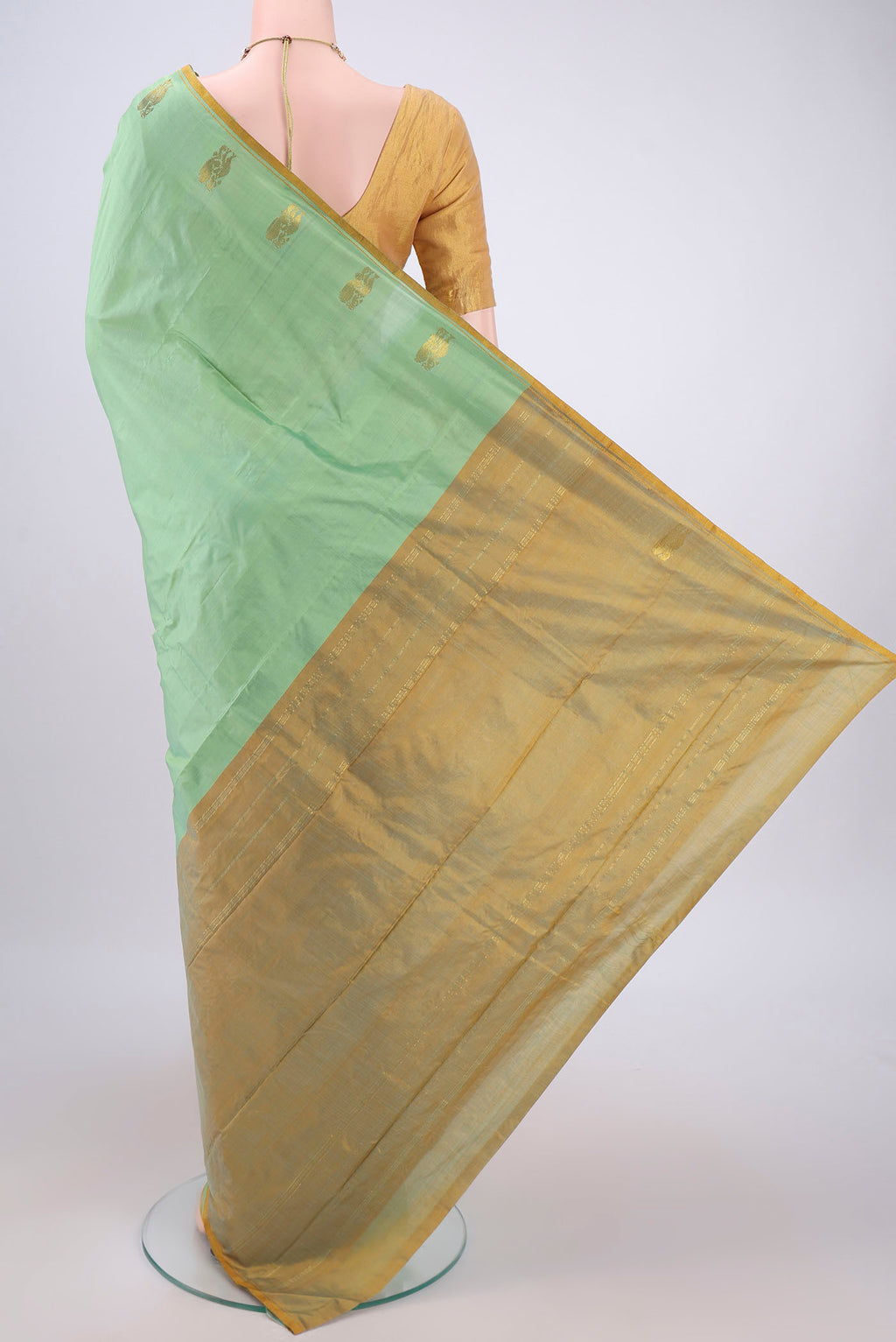 Flat view of Mint Green Kanchipuram Silk Saree with Plain Body and Thread Border. 