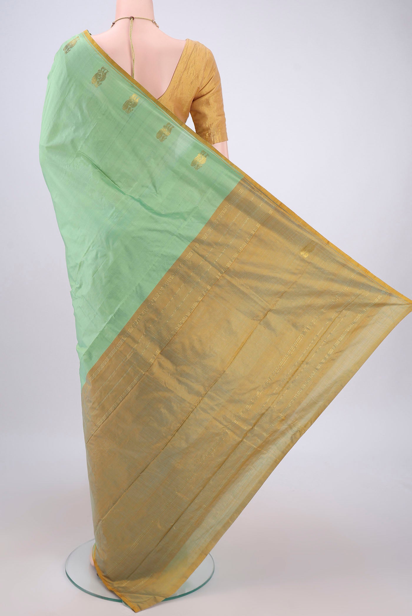 Flat view of Mint Green Kanchipuram Silk Saree with Plain Body and Thread Border. 
