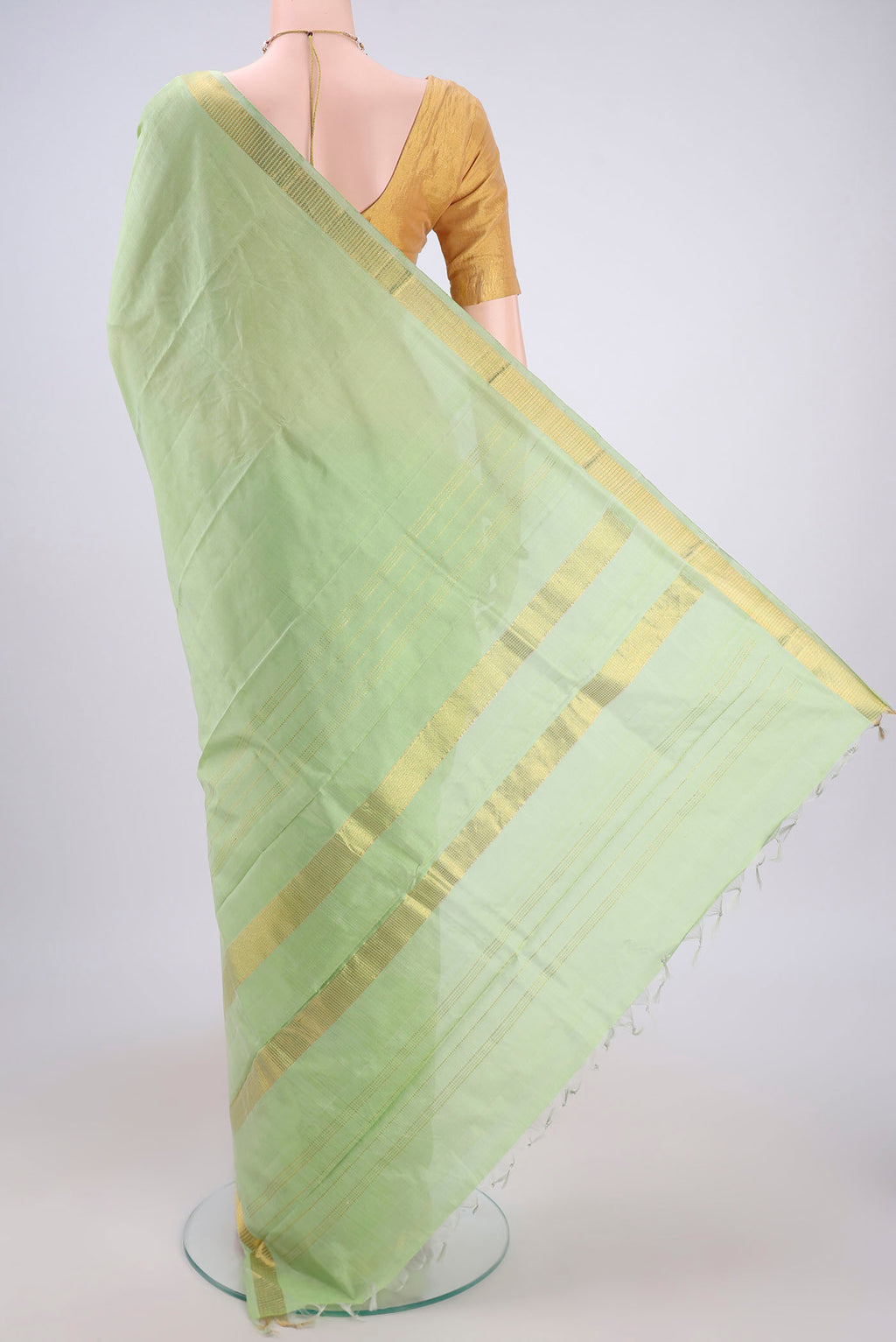 Flat view of Light Green Kanchipuram Silk Saree with Plain Body and Zari Border. 