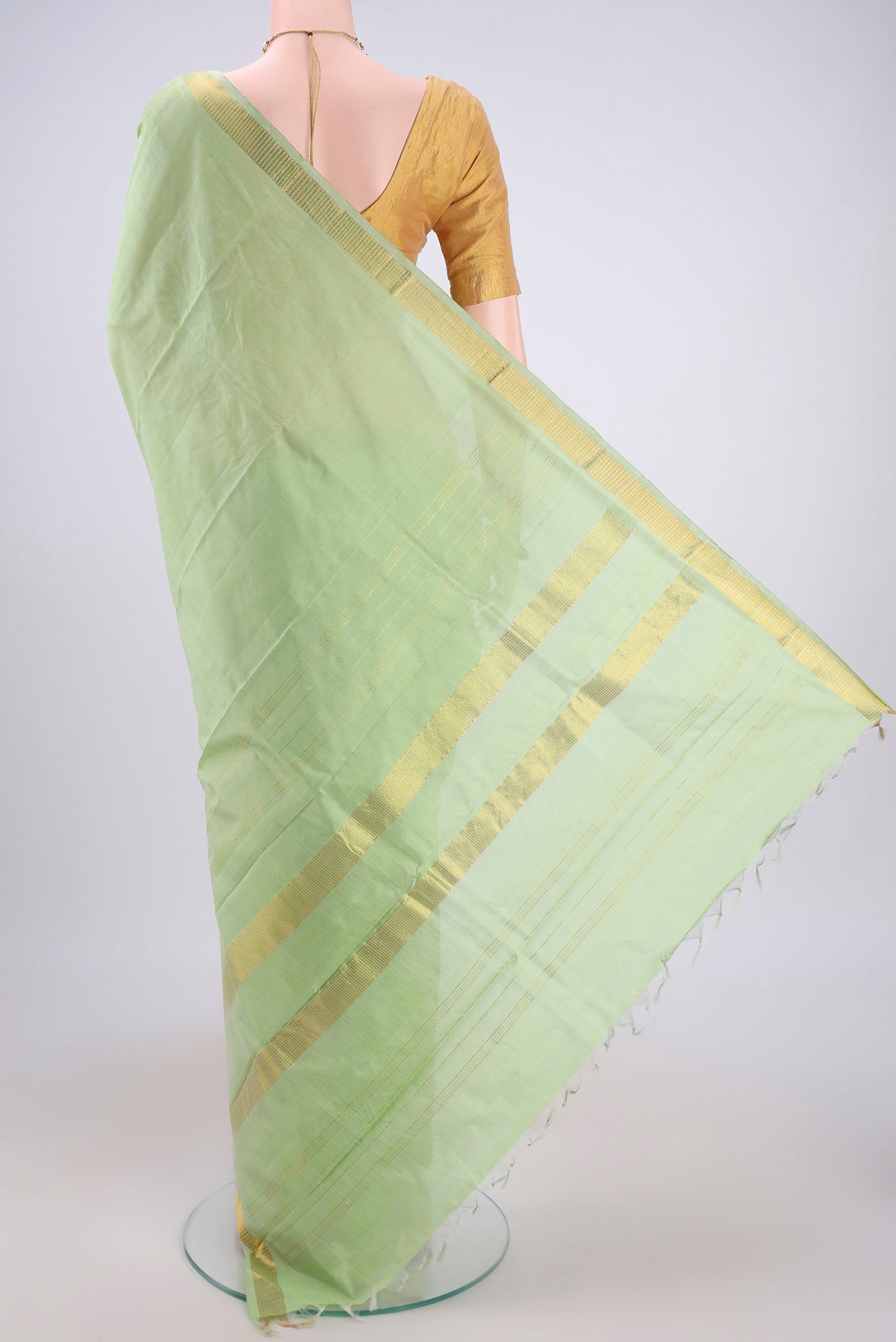 Flat view of Light Green Kanchipuram Silk Saree with Plain Body and Zari Border. 