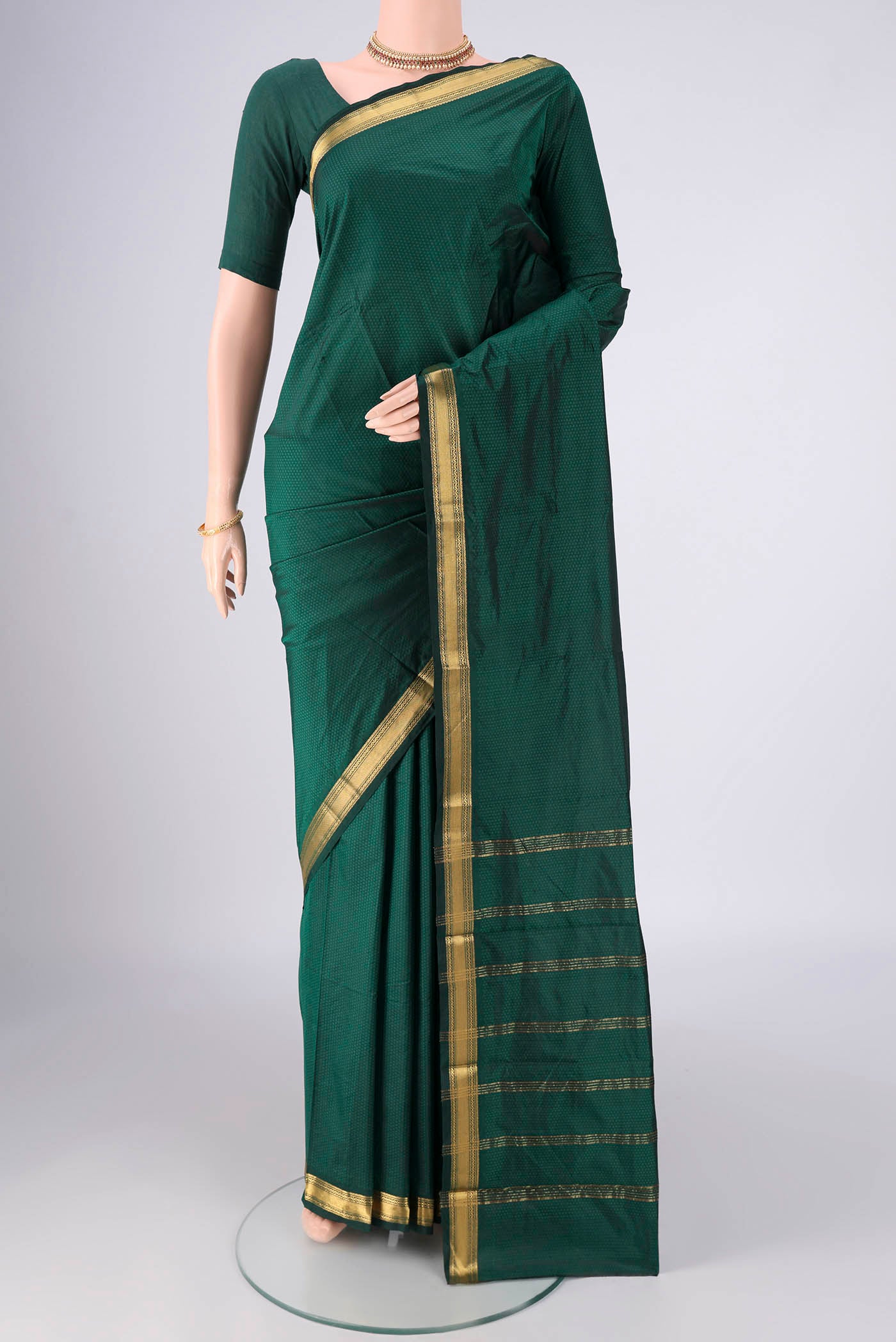 Bottle Green Blended Bangalore Silk Saree with Jacquard design on the body and Zari Border.  displayed on a mannequin