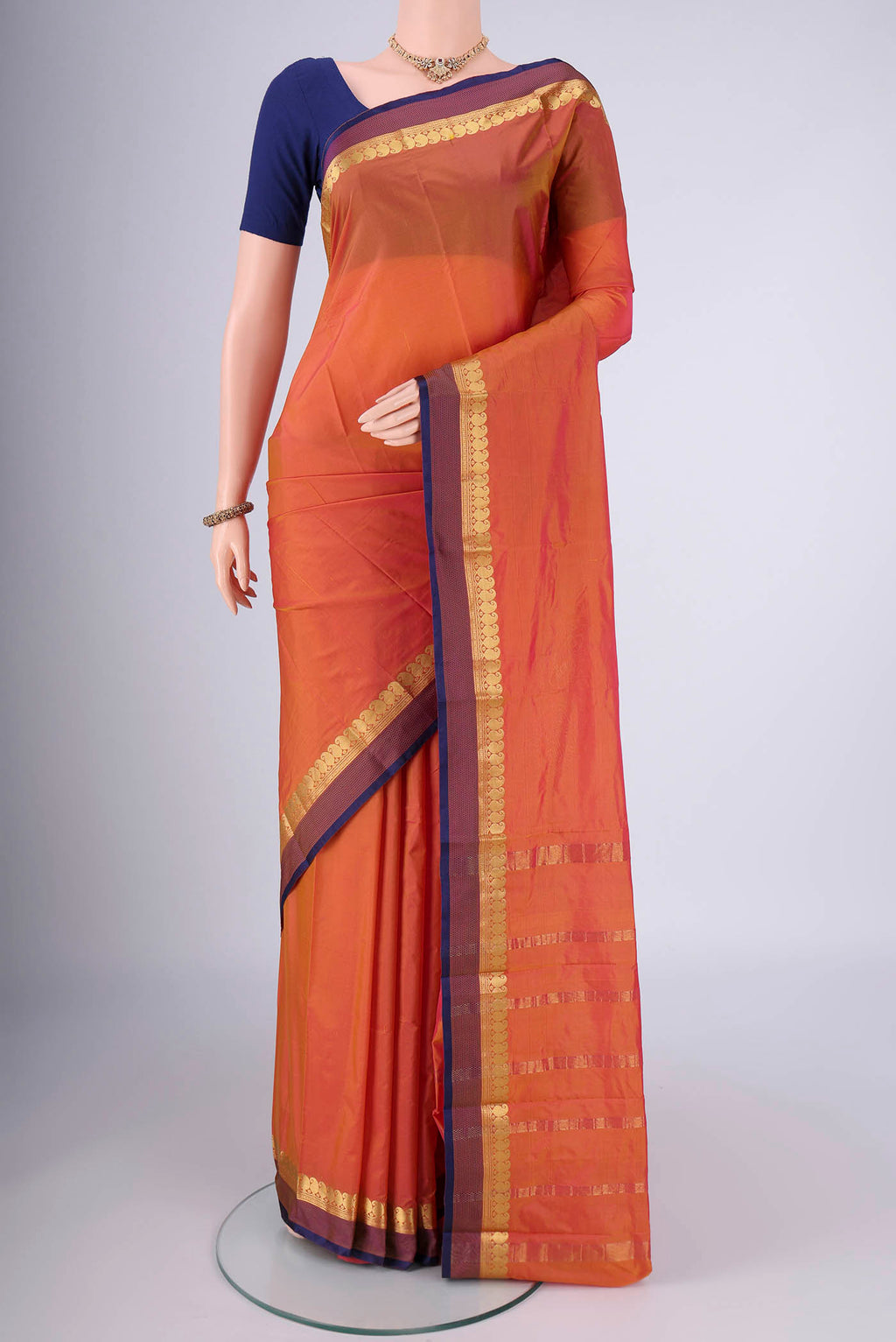 Brick Orange Blended Bangalore Silk Saree with Plain Body and Zari Border.  displayed on a mannequin