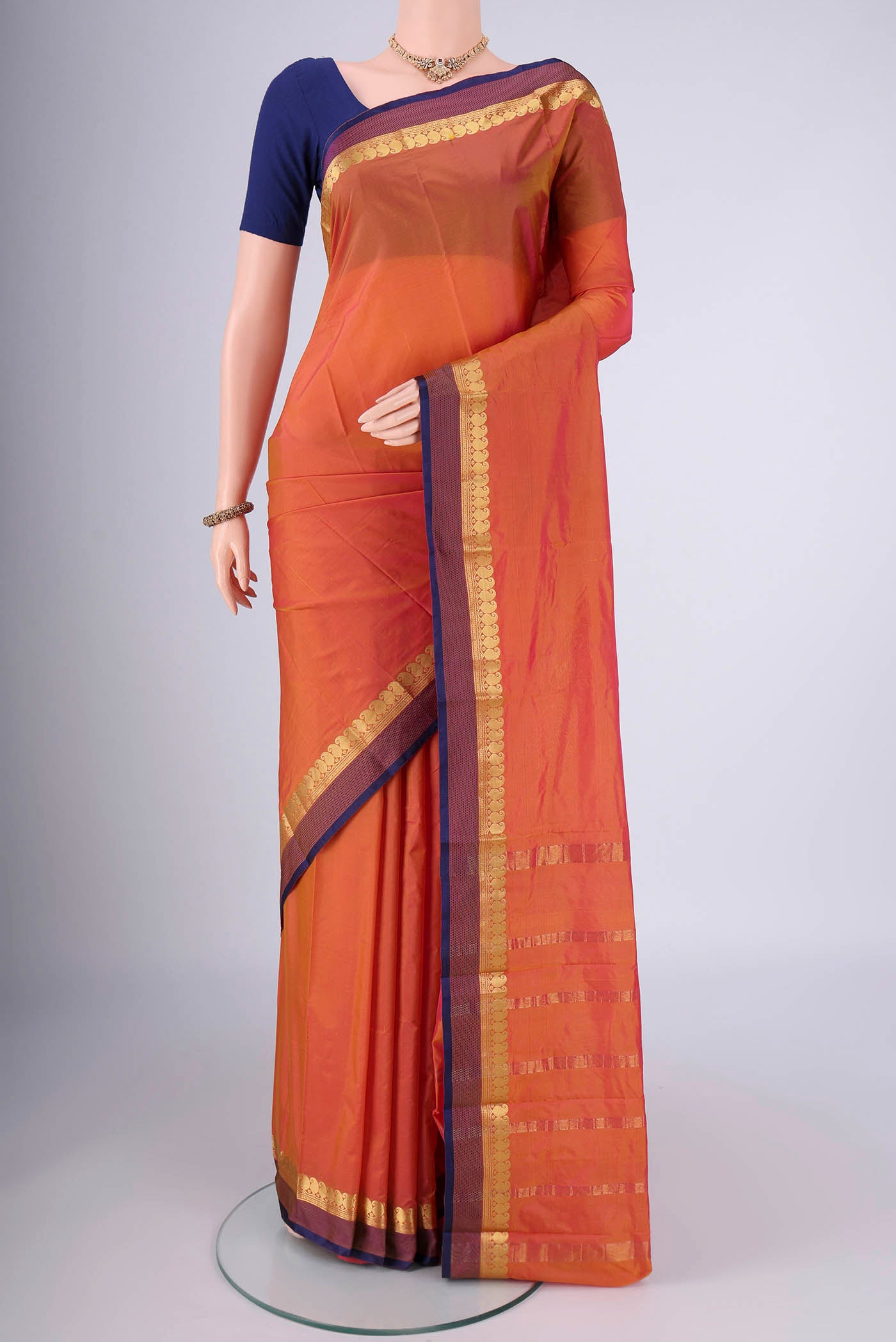 Brick Orange Blended Bangalore Silk Saree with Plain Body and Zari Border.  displayed on a mannequin