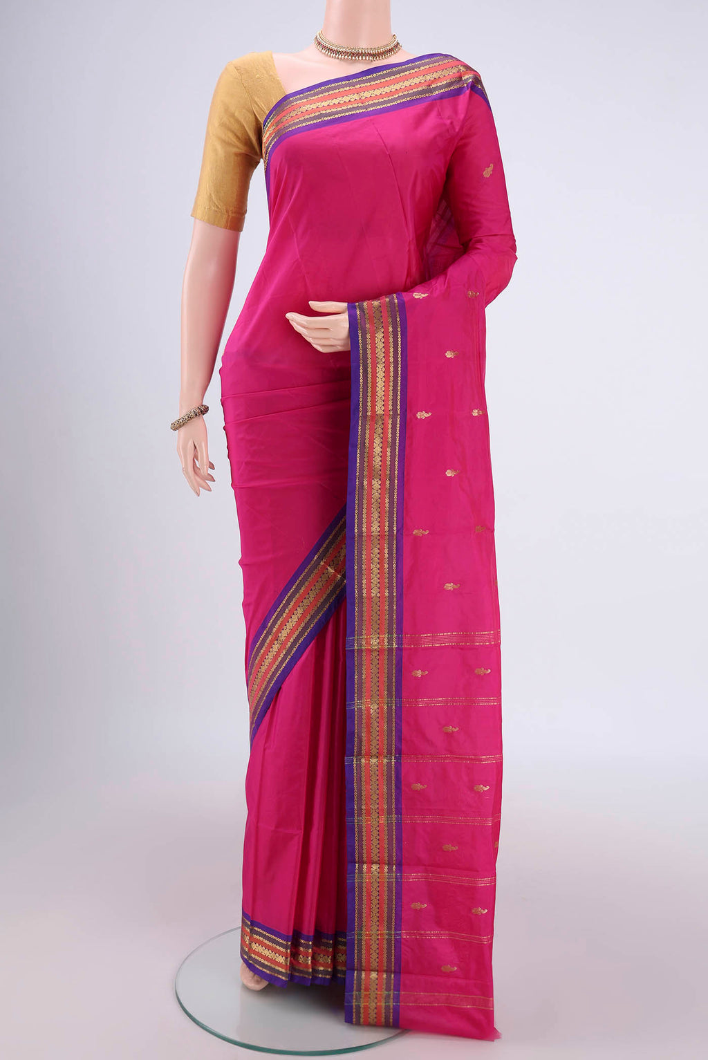 Rani Pink Bangalore Silk Saree with Thread Butta on the body and Zari Border.  displayed on a mannequin