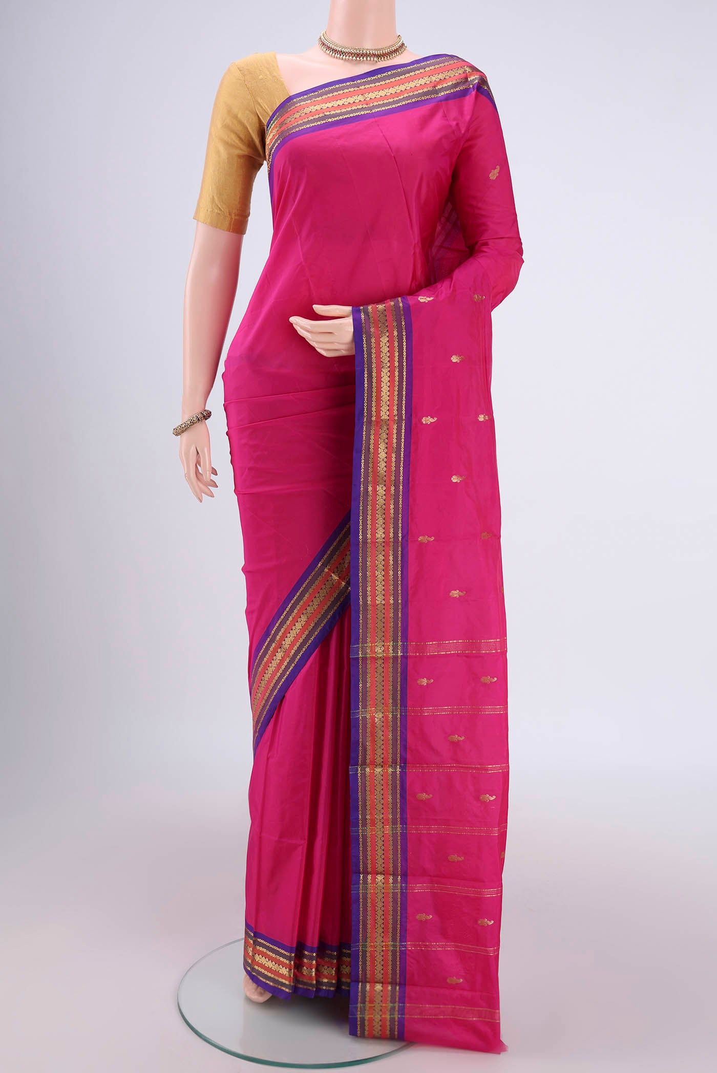 Rani Pink Bangalore Silk Saree with Thread Butta on the body and Zari Border.  displayed on a mannequin