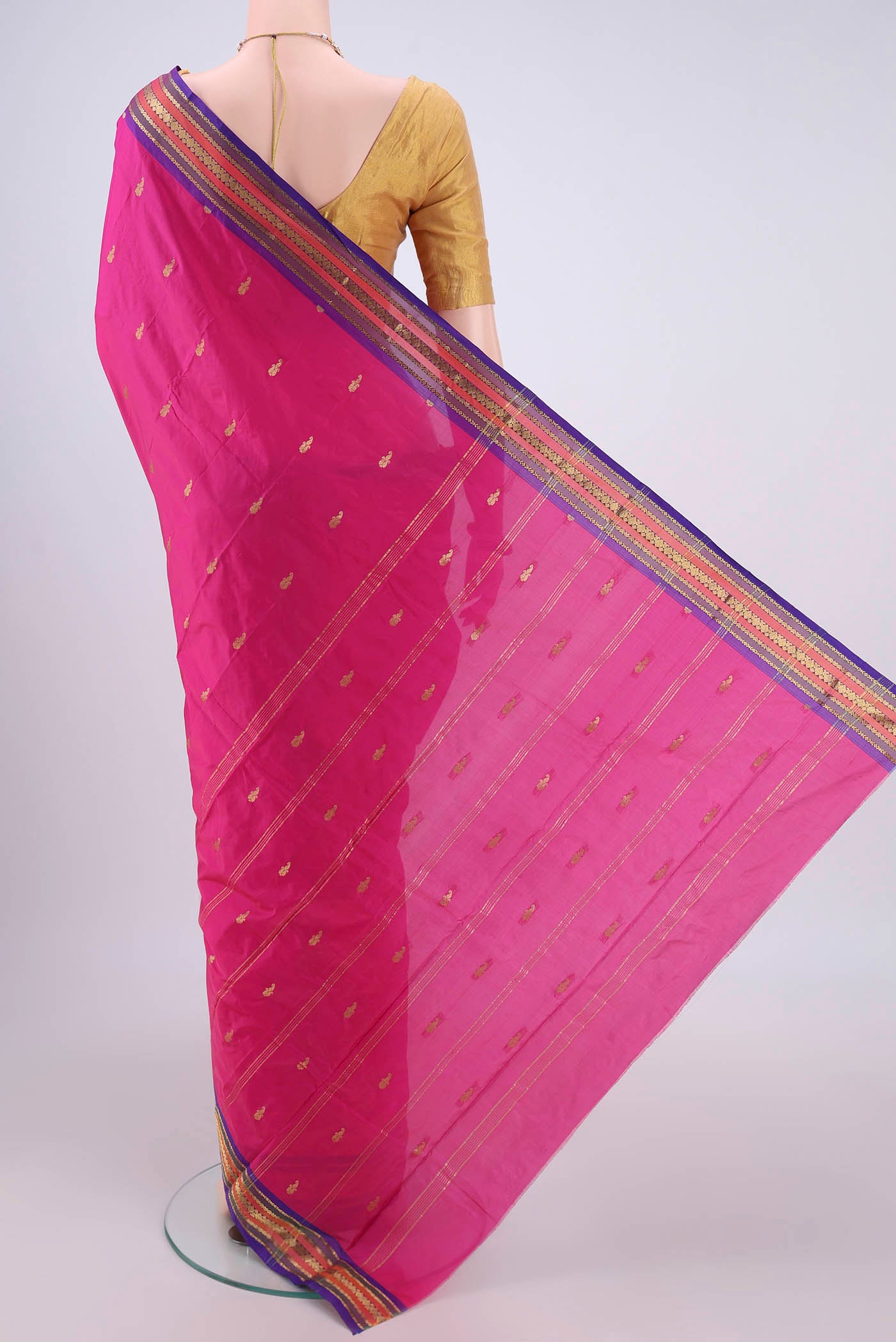 Flat view of Rani Pink Bangalore Silk Saree with Thread Butta on the body and Zari Border. 