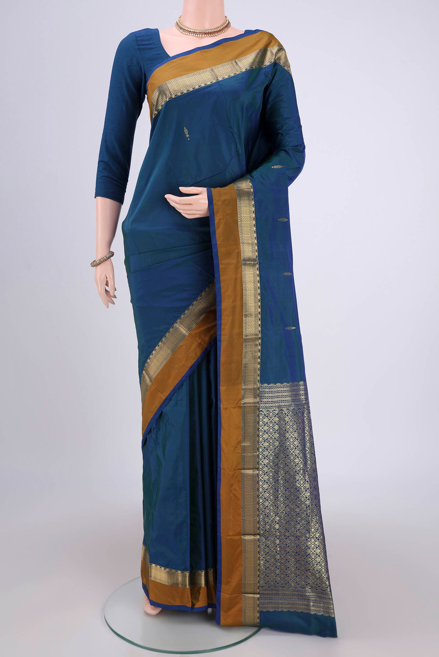 Peacock Blue Blended Bangalore Silk Saree with Zari Butta on the body and Zari Border.  displayed on a mannequin