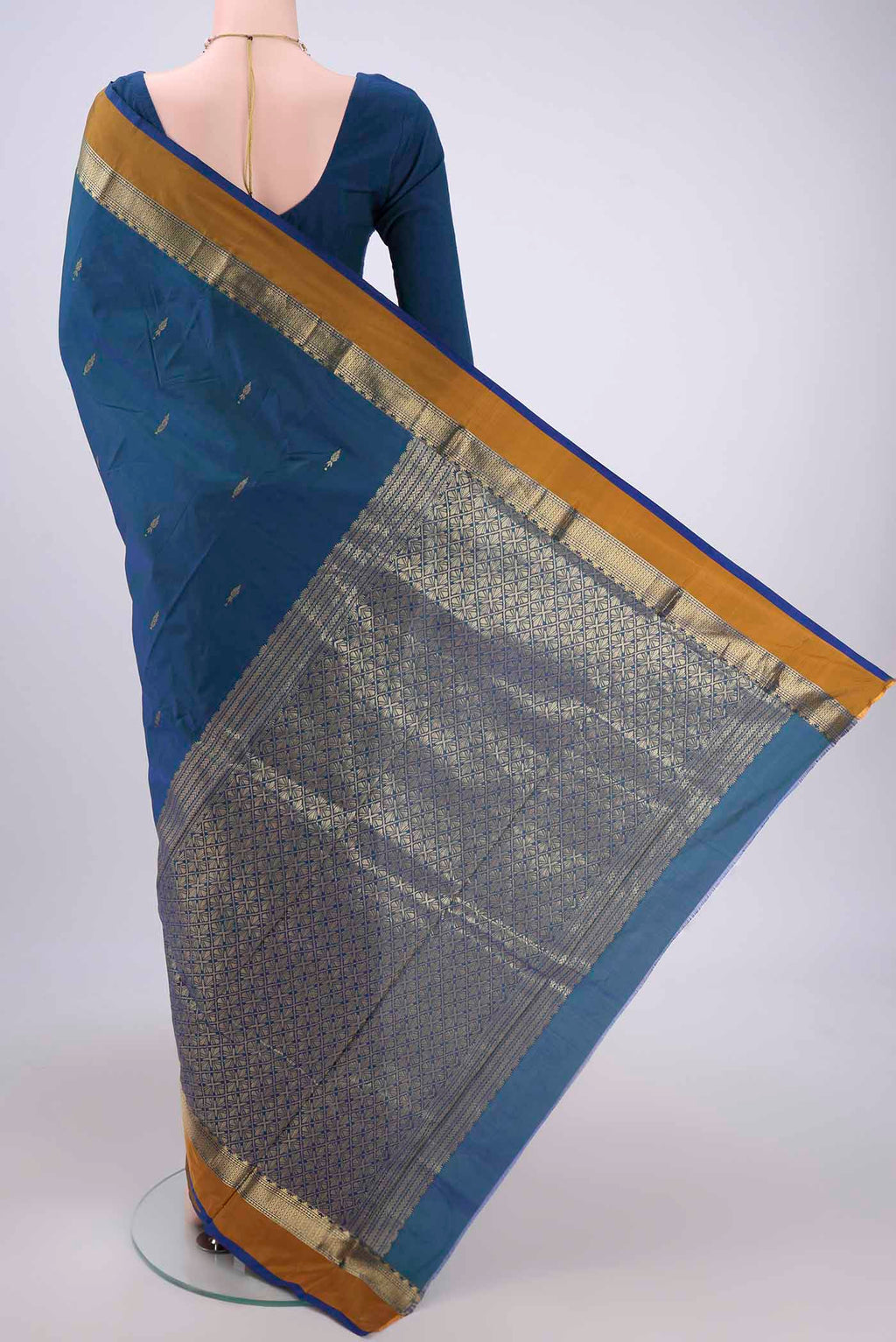 Flat view of Peacock Blue Blended Bangalore Silk Saree with Zari Butta on the body and Zari Border. 