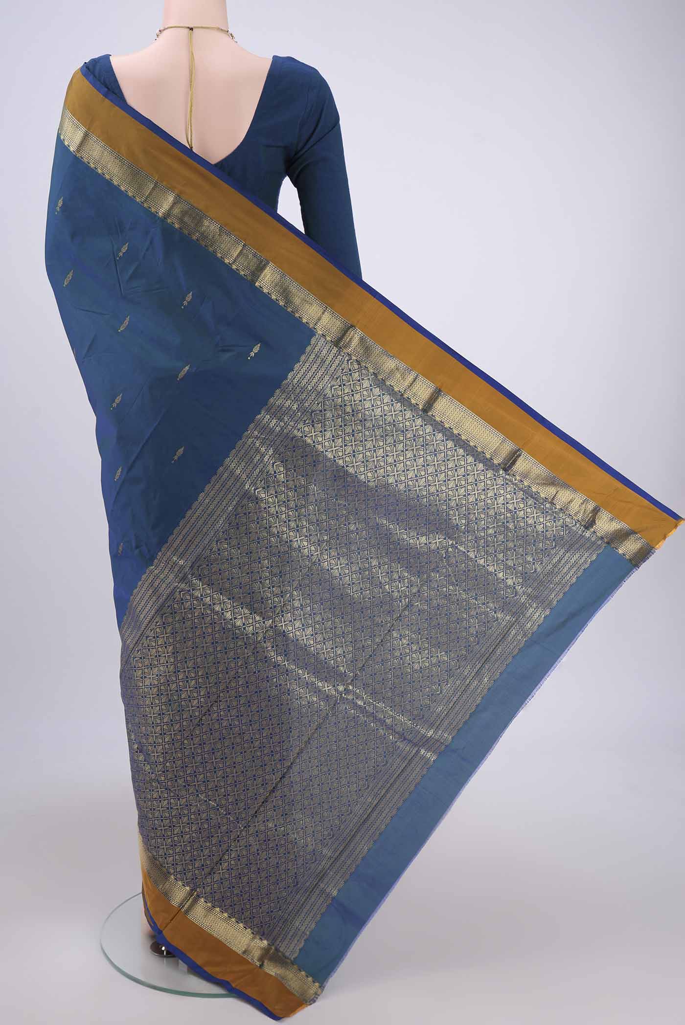 Flat view of Peacock Blue Blended Bangalore Silk Saree with Zari Butta on the body and Zari Border. 