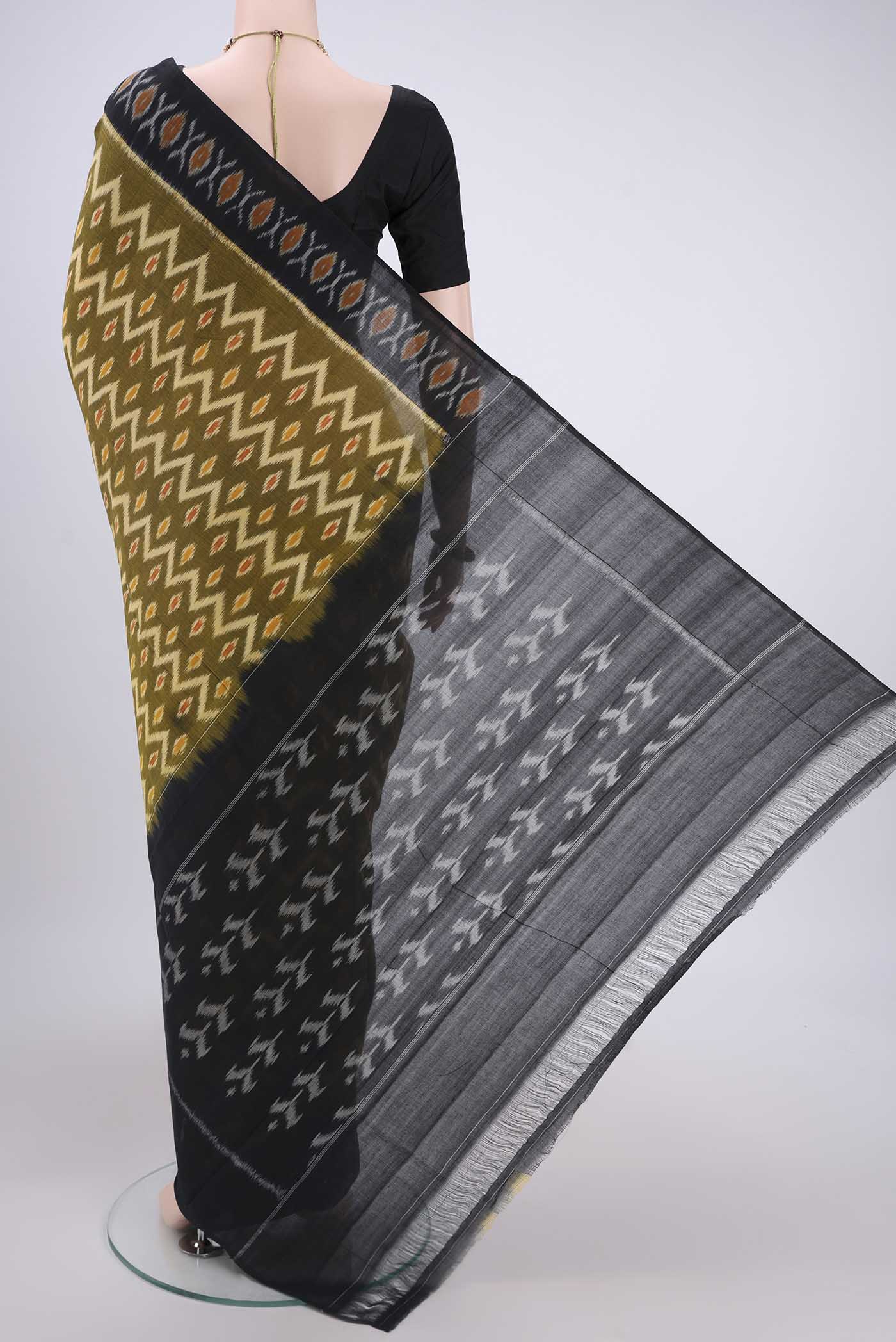 Flat view of Mehandi Green Pochampally Cotton Saree with Ikat design on the body and Ikat Border. 