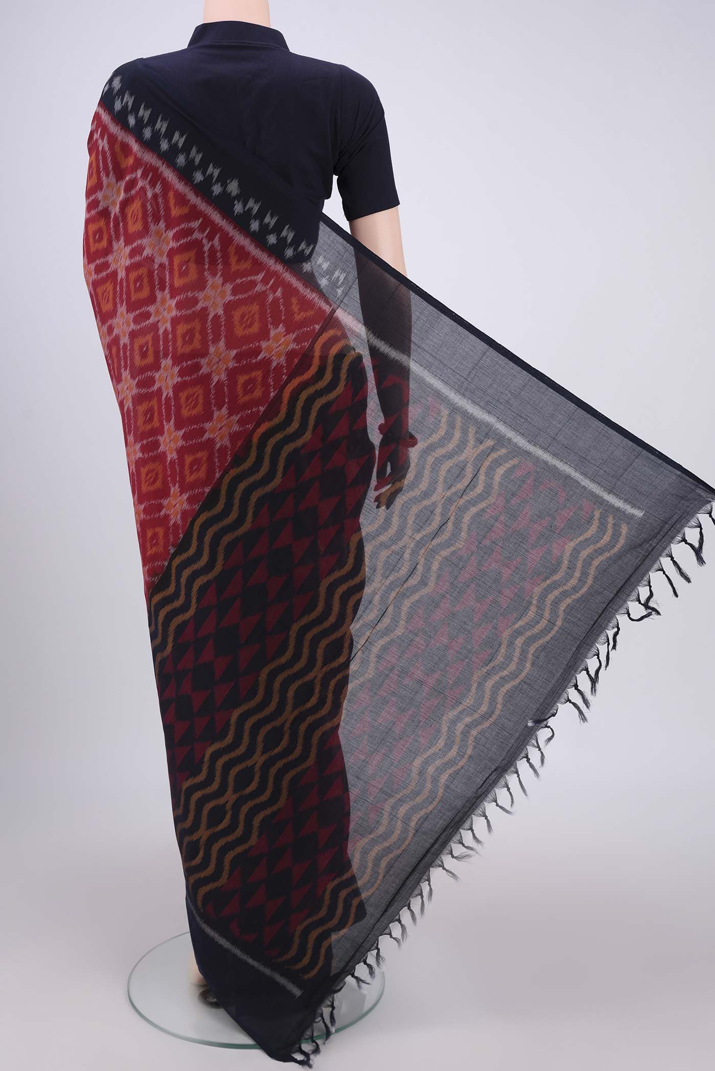 Flat view of Maroon Pochampally Cotton Saree with Ikat design on the body and Ikat Border. 