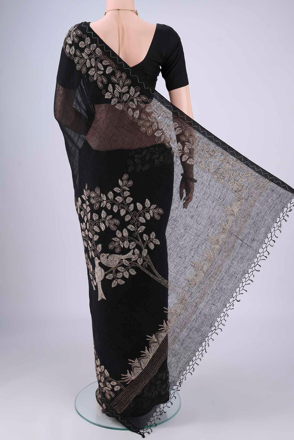 Flat view of Black Linen Cotton Saree with Kantha Work on the body and Thread Border. 