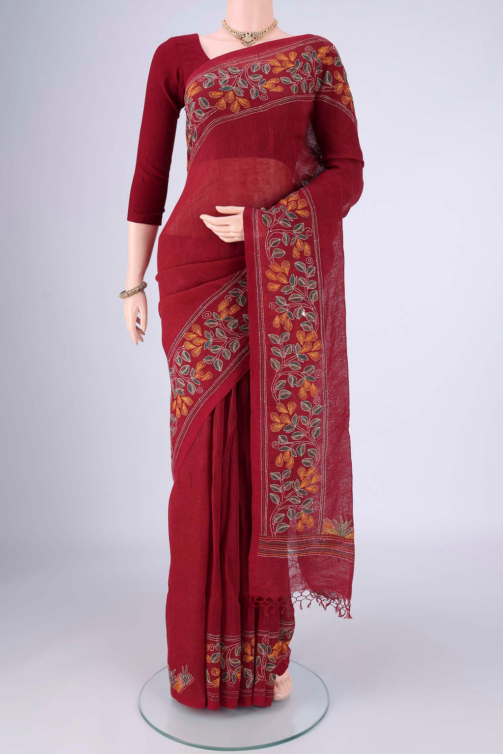 Maroon Linen Cotton Saree with Kantha Work on the body and Thread Border.  displayed on a mannequin