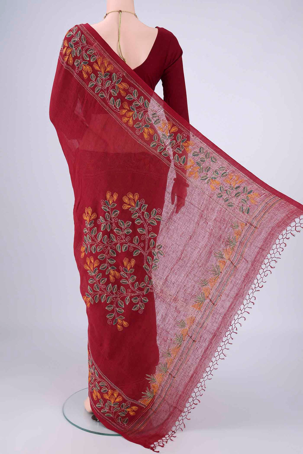 Flat view of Maroon Linen Cotton Saree with Kantha Work on the body and Thread Border. 