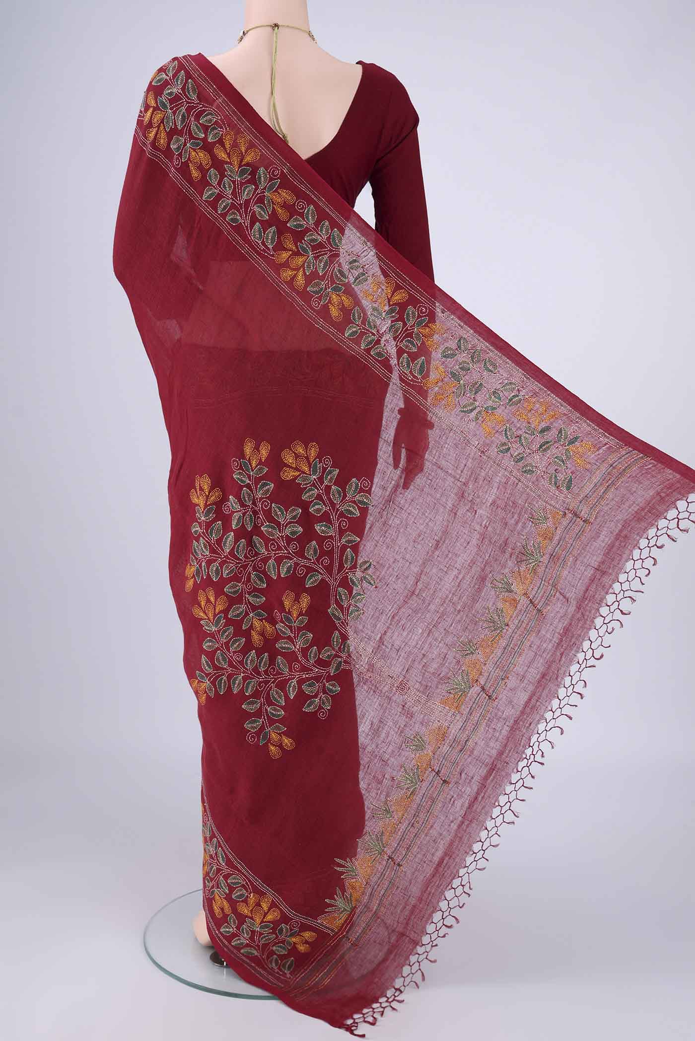Flat view of Maroon Linen Cotton Saree with Kantha Work on the body and Thread Border. 