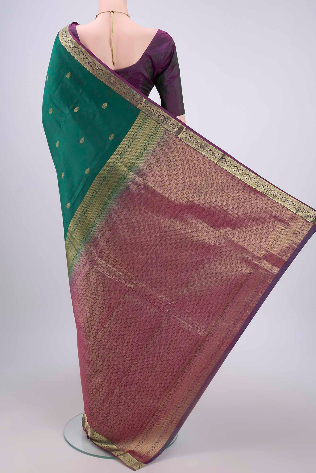 Flat view of Bottle Green Kanjivaram Silk Saree with Zari Butta on the body and Zari Border. 