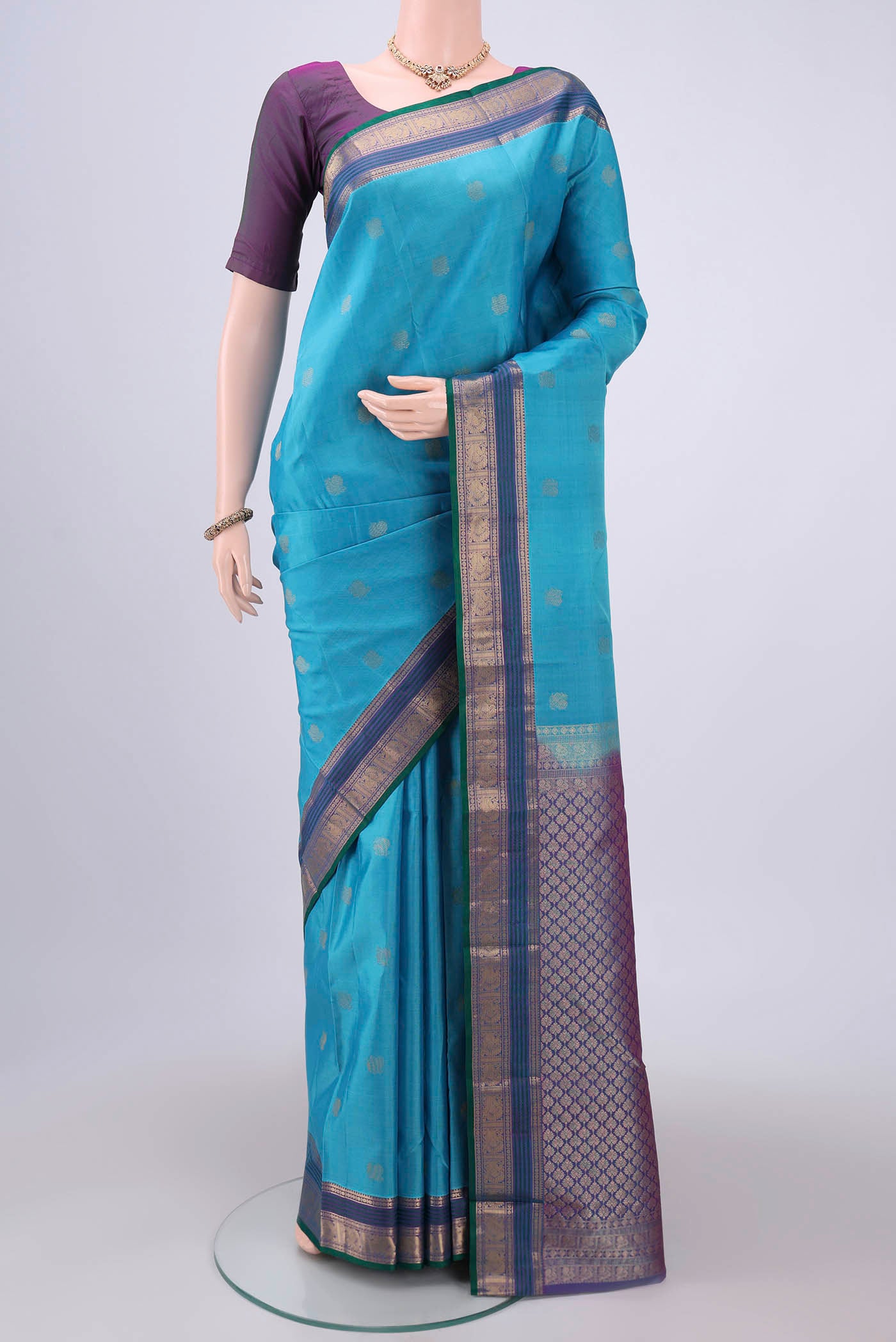 Blue Kanchipuram Silk Saree with Zari Butta on the body and Zari Border.  displayed on a mannequin