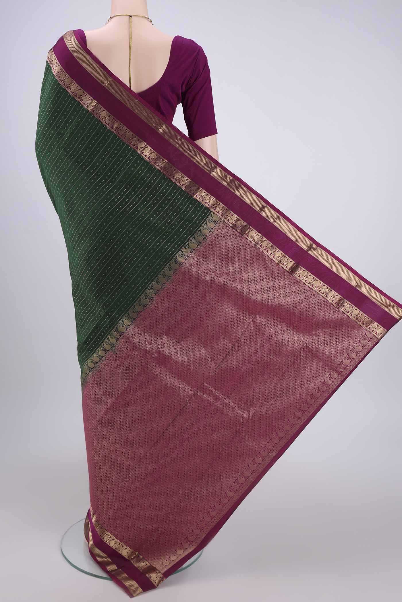 Flat view of Bottle Green Kanchipuram Silk Saree with Zari Butta on the body and Zari Border. 