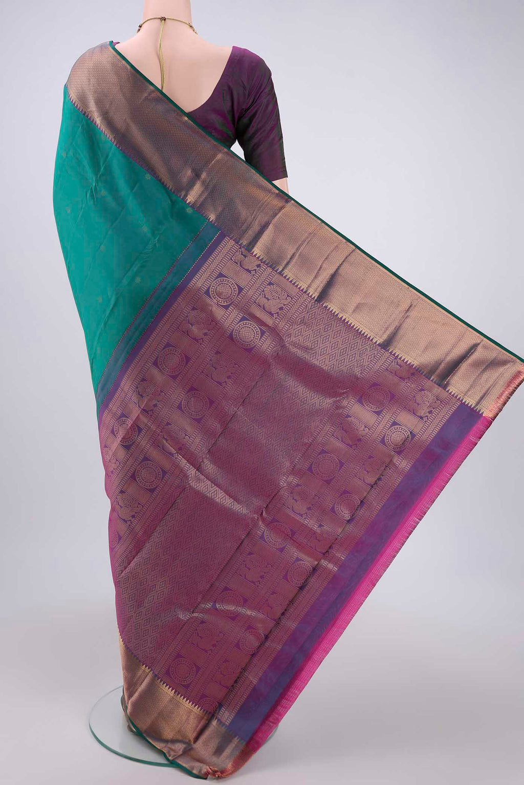 Flat view of Green Kanchipuram Silk Saree with Zari Butta on the body and Zari Border. 