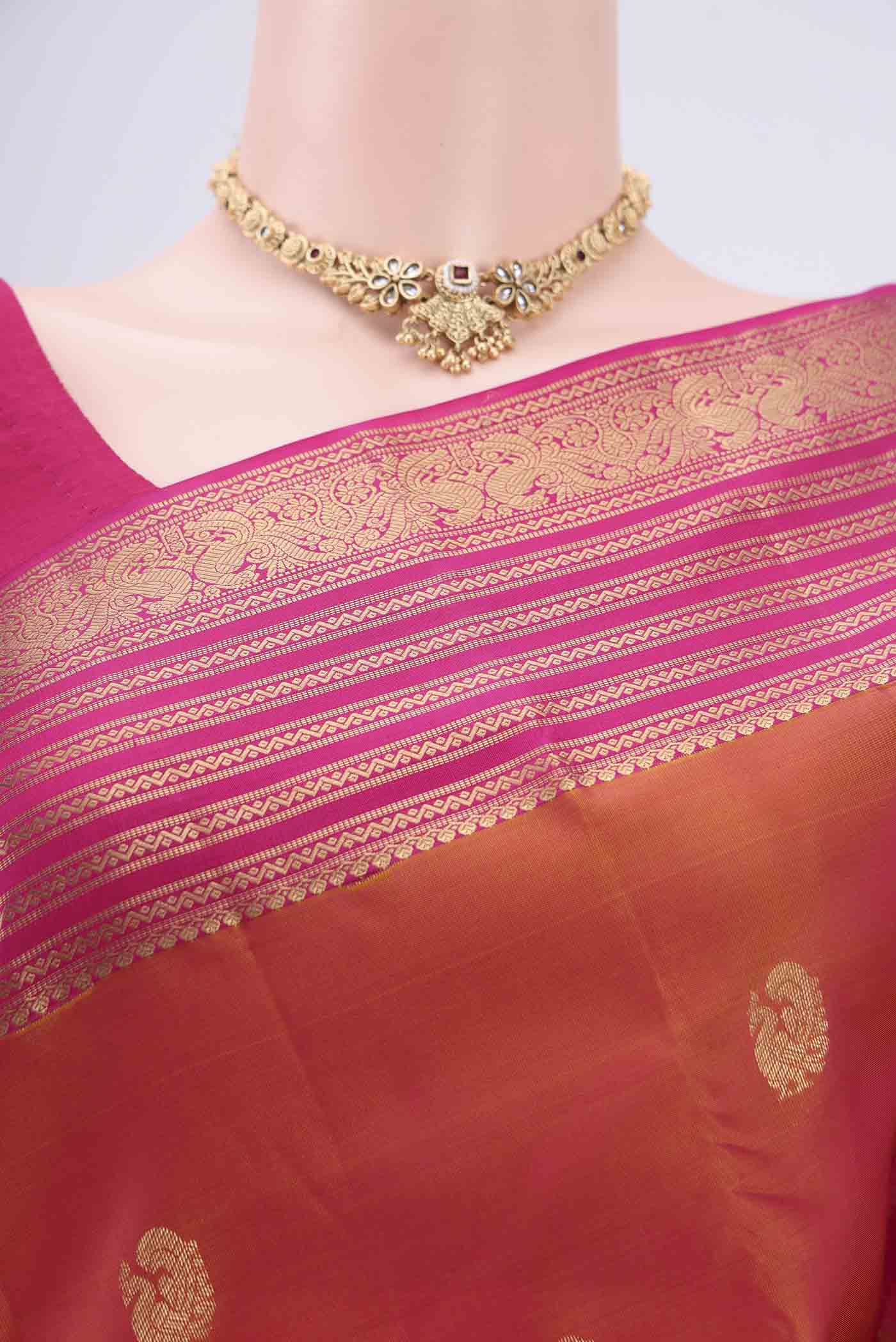 Border image of Brick Orange Kanchipuram Silk Saree with Zari Butta on the body and Zari Border. 