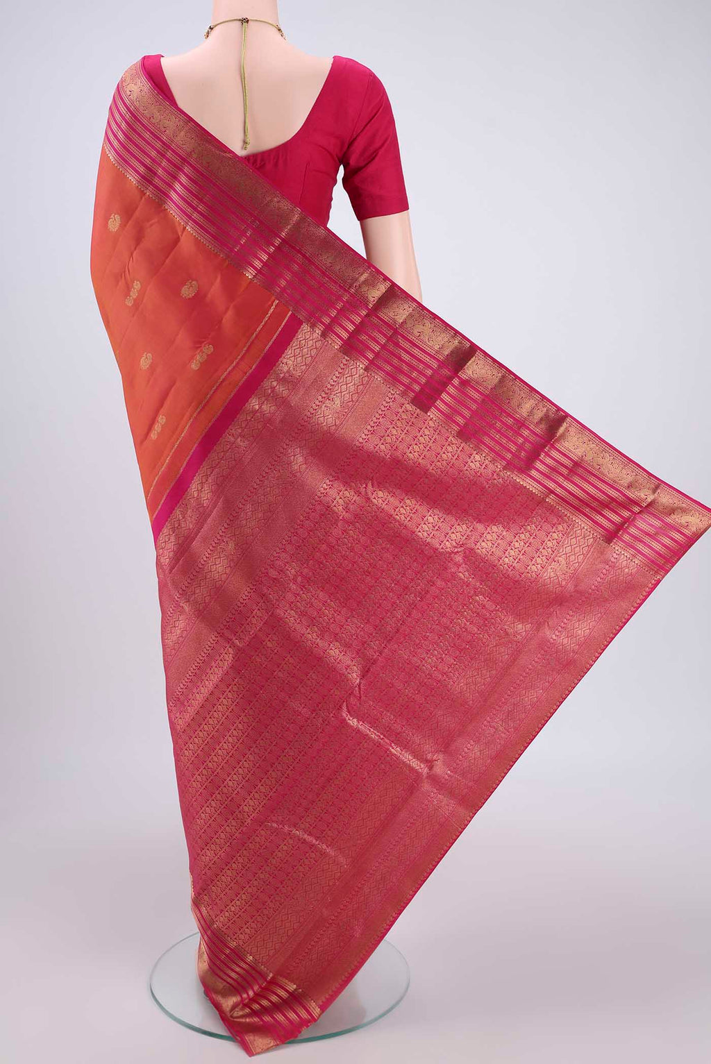 Flat view of Brick Orange Kanchipuram Silk Saree with Zari Butta on the body and Zari Border. 