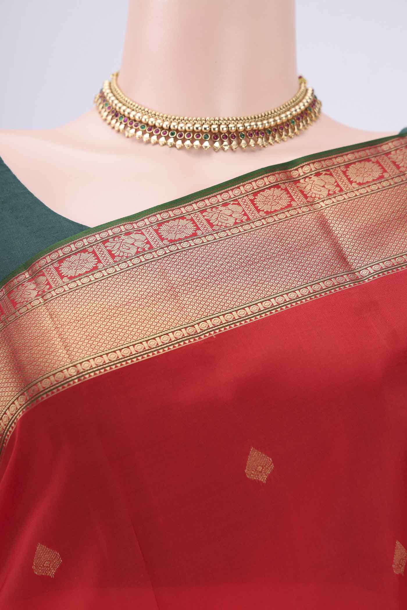 Border image of Red Kanchipuram Silk Saree with Zari Butta on the body and Zari Border. 