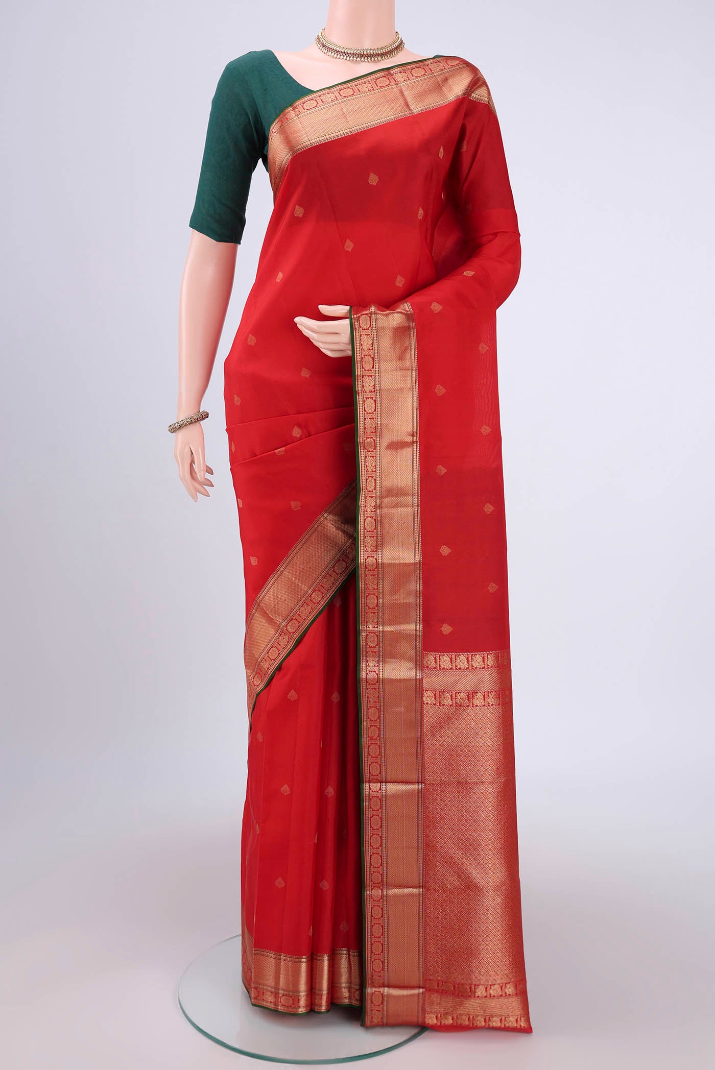Red Kanchipuram Silk Saree with Zari Butta on the body and Zari Border.  displayed on a mannequin