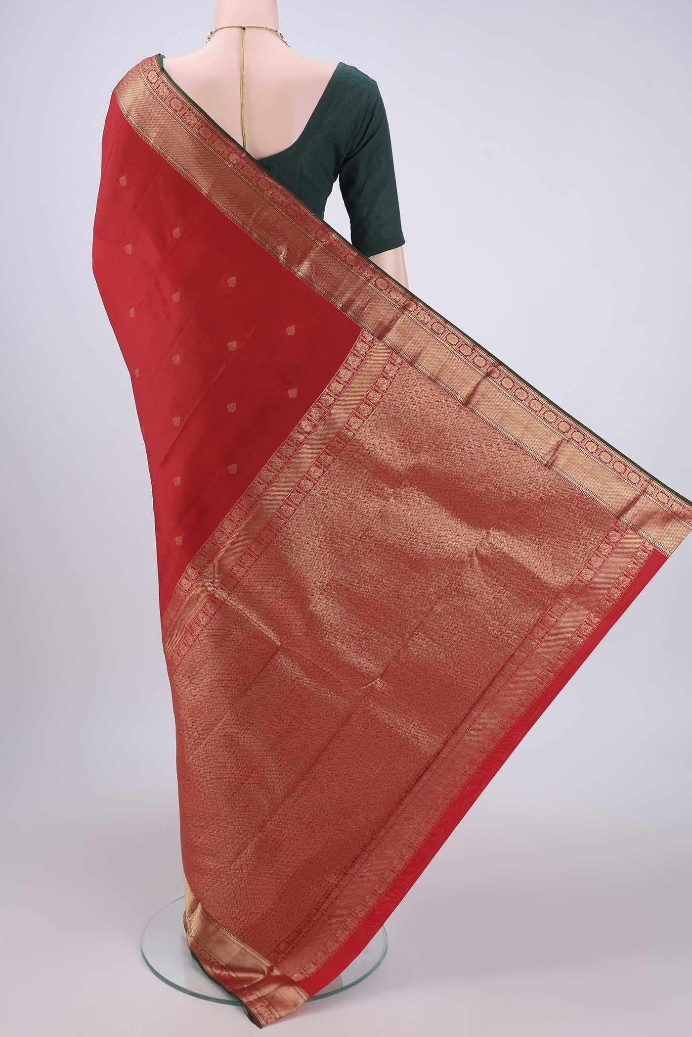Flat view of Red Kanchipuram Silk Saree with Zari Butta on the body and Zari Border. 