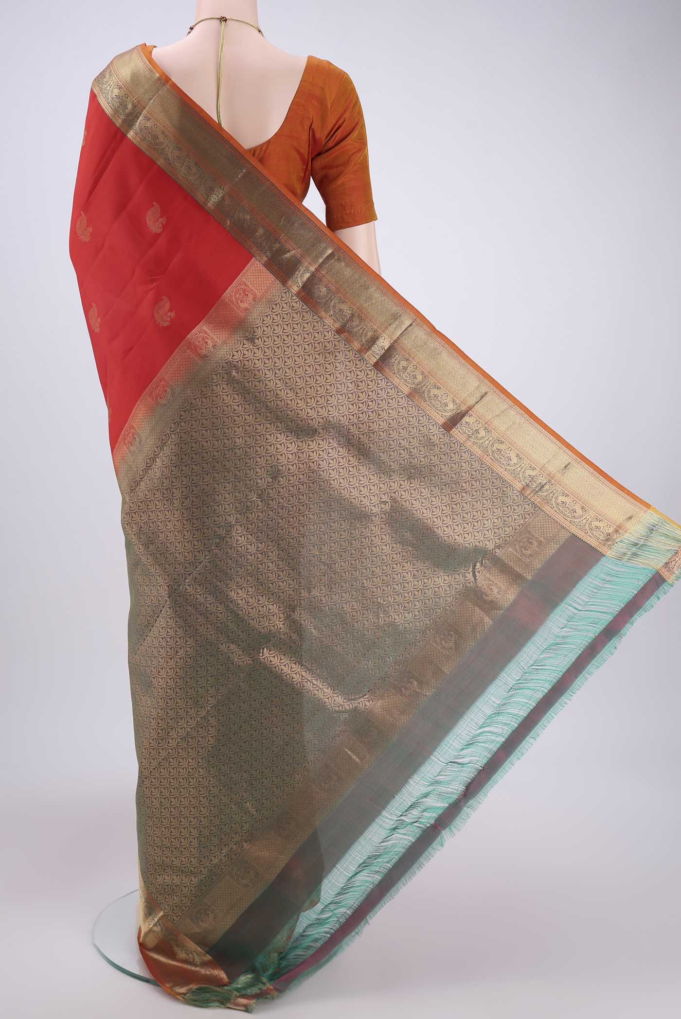 Flat view of Red Kanchipuram Silk Saree with Zari Butta on the body and Zari Border. 