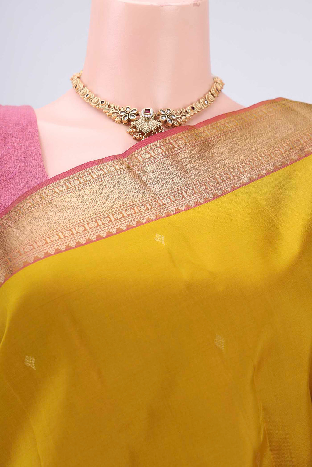 Border image of Mustard Kanchipuram Silk Saree with Zari Butta on the body and Zari Border. 
