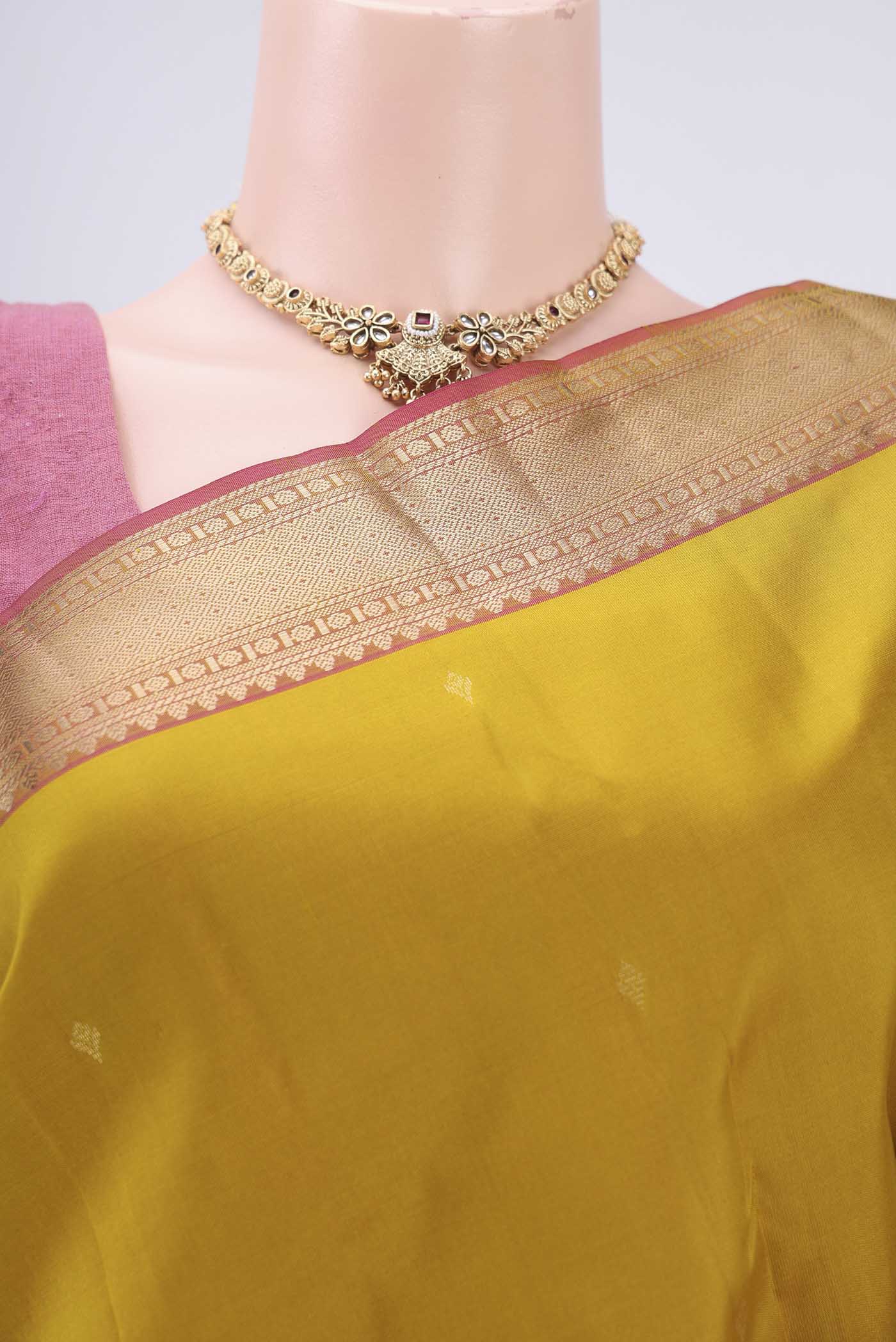 Border image of Mustard Kanchipuram Silk Saree with Zari Butta on the body and Zari Border. 