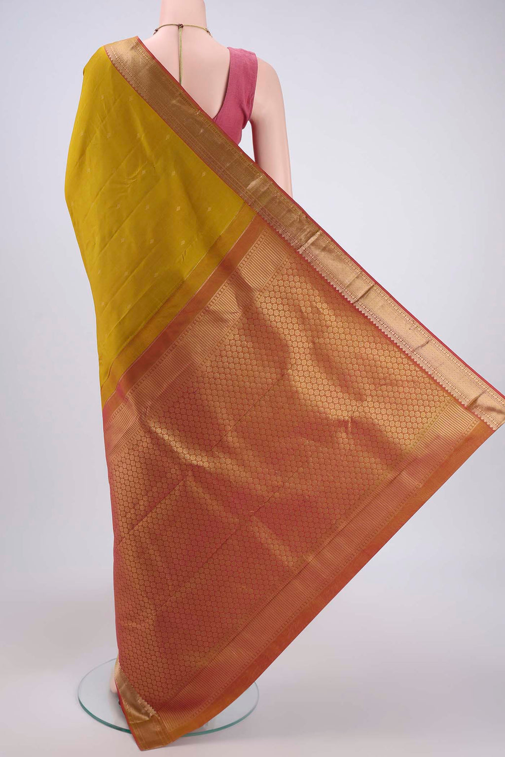 Flat view of Mustard Kanchipuram Silk Saree with Zari Butta on the body and Zari Border. 