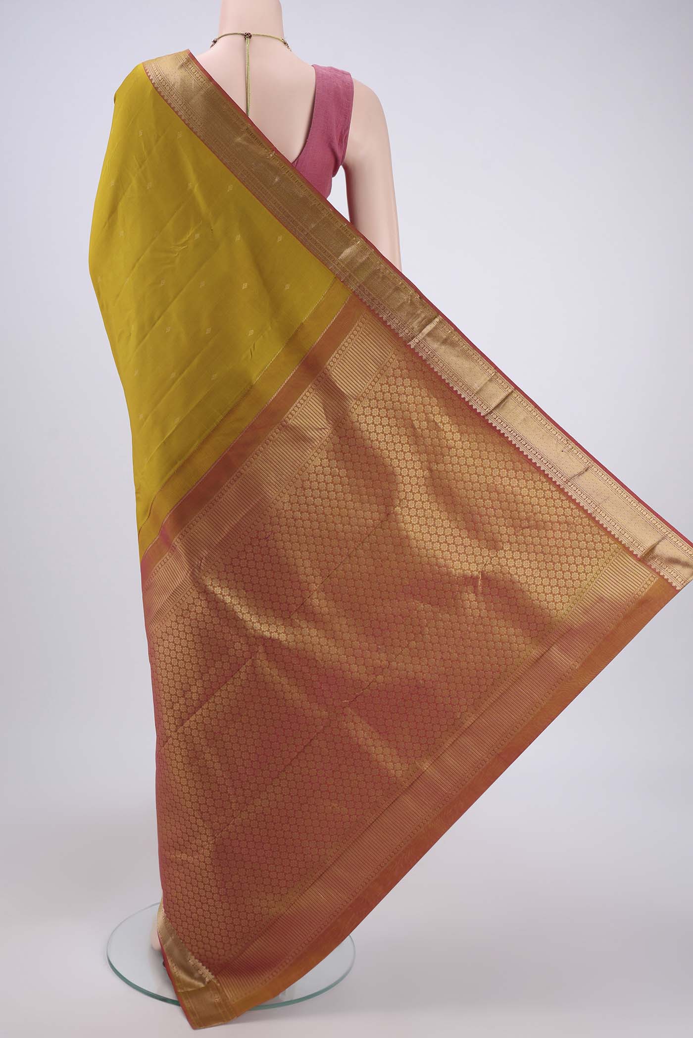 Flat view of Mustard Kanchipuram Silk Saree with Zari Butta on the body and Zari Border. 