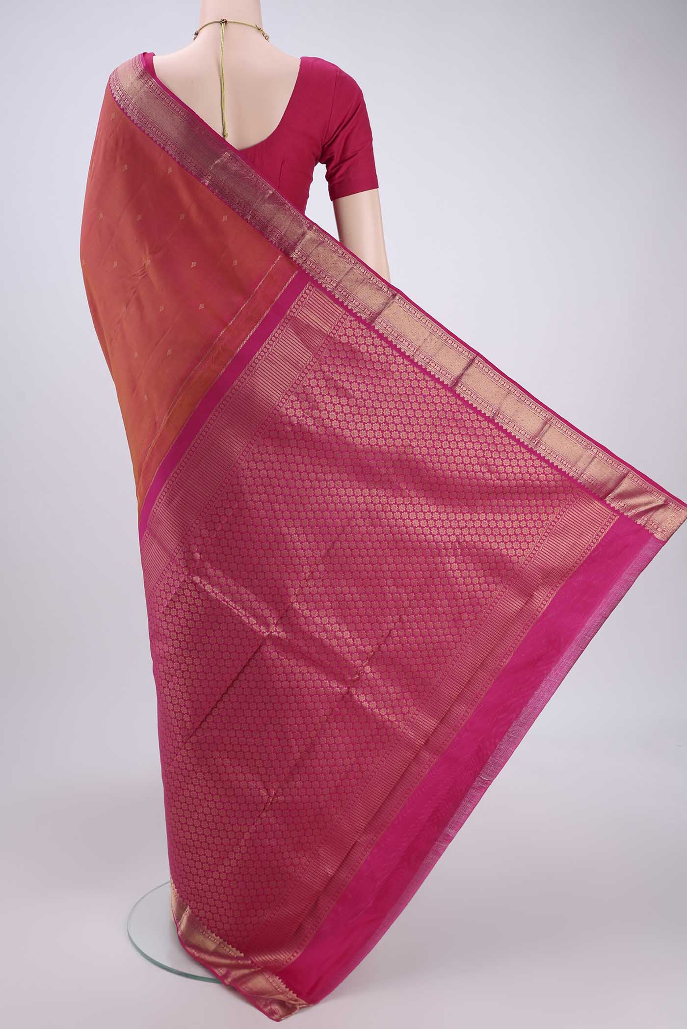 Flat view of Pinkish Yellow Kanchipuram Silk Saree with Zari Butta on the body and Zari Border. 