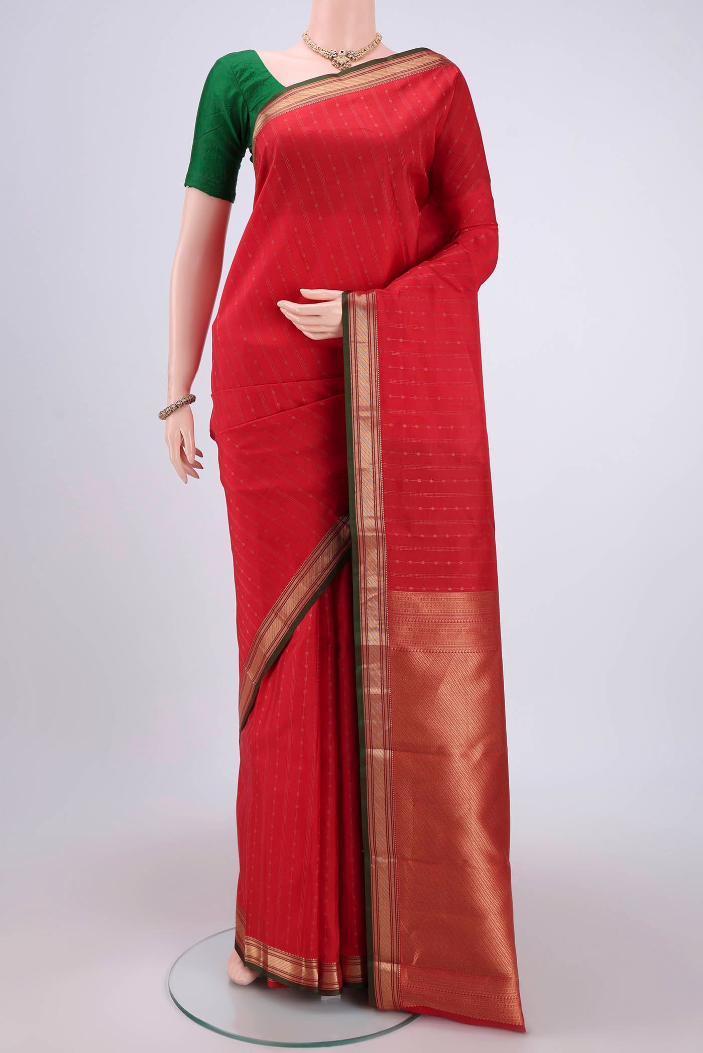 Imperial Red Kanchipuram Silk Saree with Zari Butta on the body and Zari Border.  displayed on a mannequin