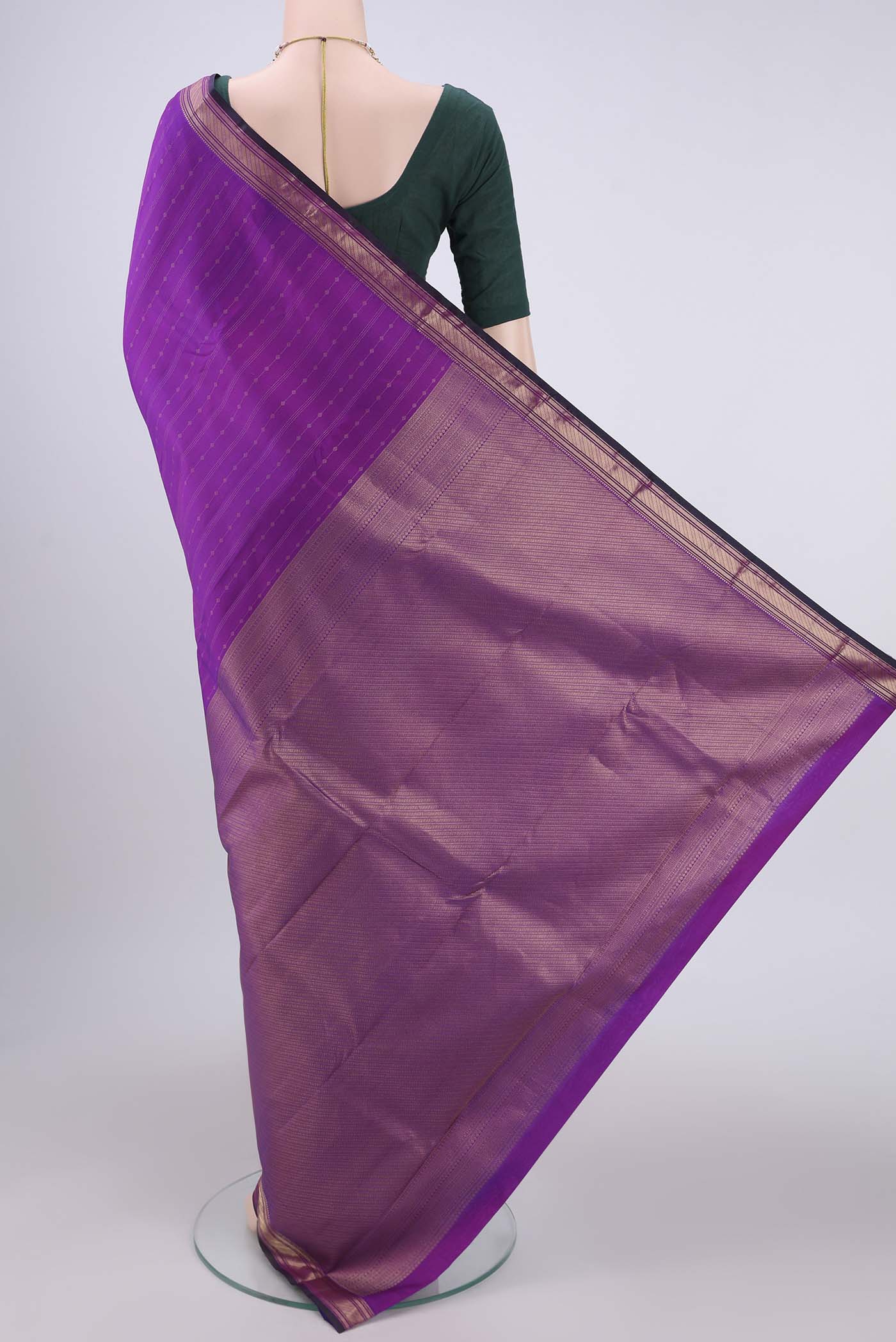 Flat view of Magenta Kanchipuram Silk Saree with Zari Butta on the body and Zari Border. 